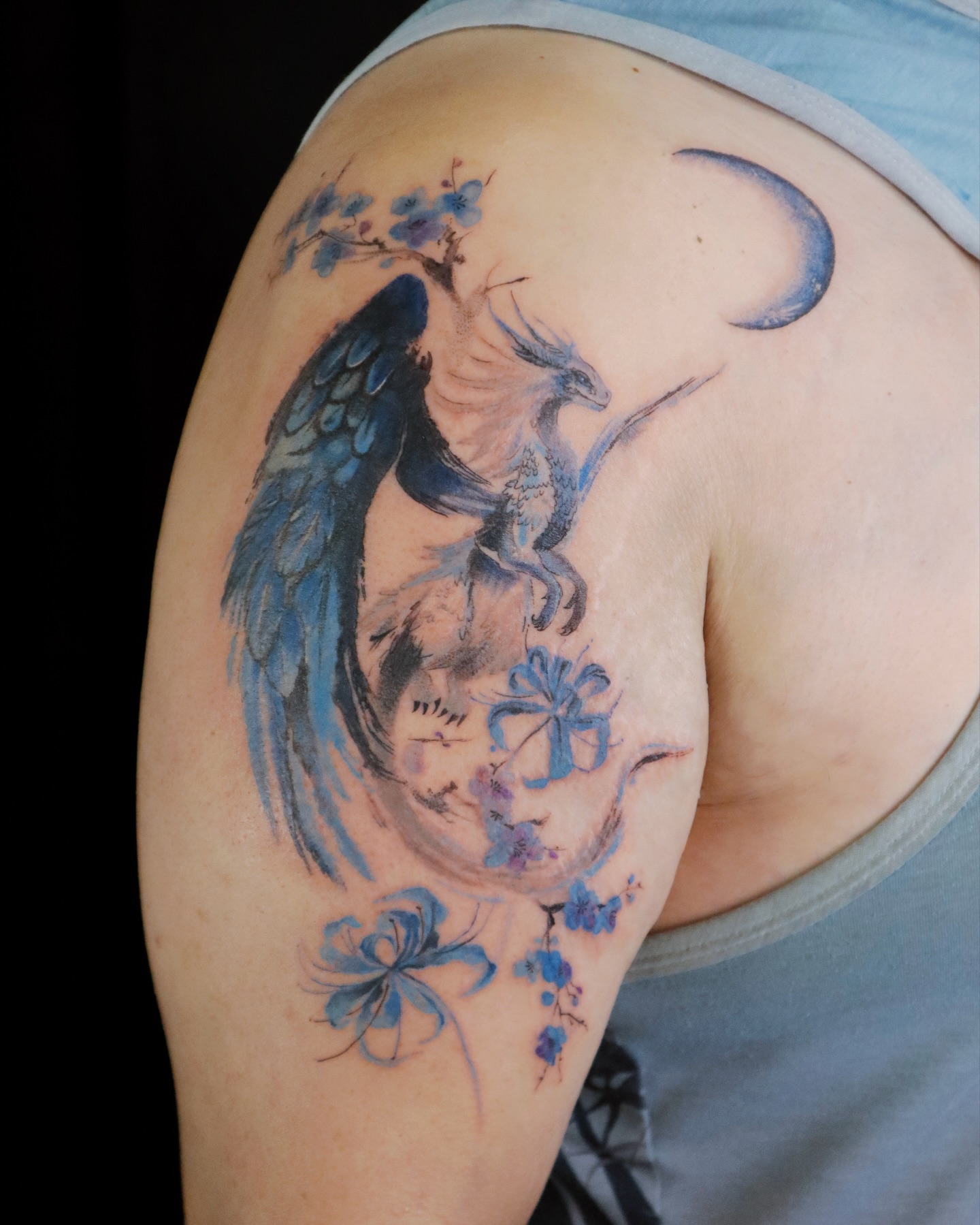 Phoenix and blossoms watercolor tattoo on the shoulder by Sylvia｜思岐, Vancouver, British Columbia
