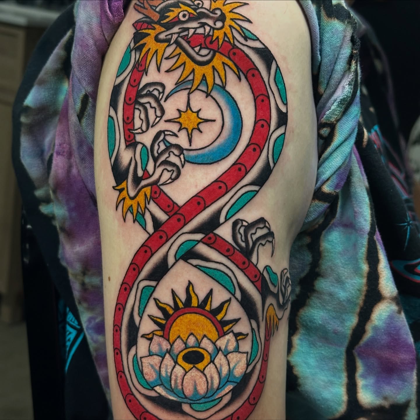 Serpent and lotus American traditional tattoo on the forearm by Emily Masa