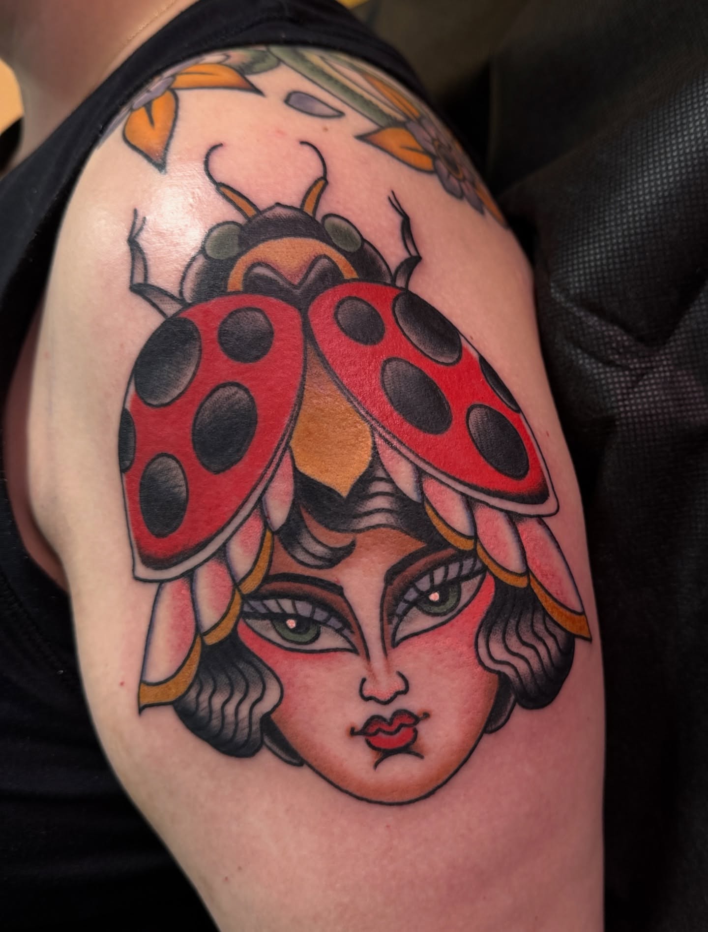Ladybug American traditional tattoo on the shoulder by Tannis - Traditional Tattoos in Richmond, VA, Richmond, Virginia