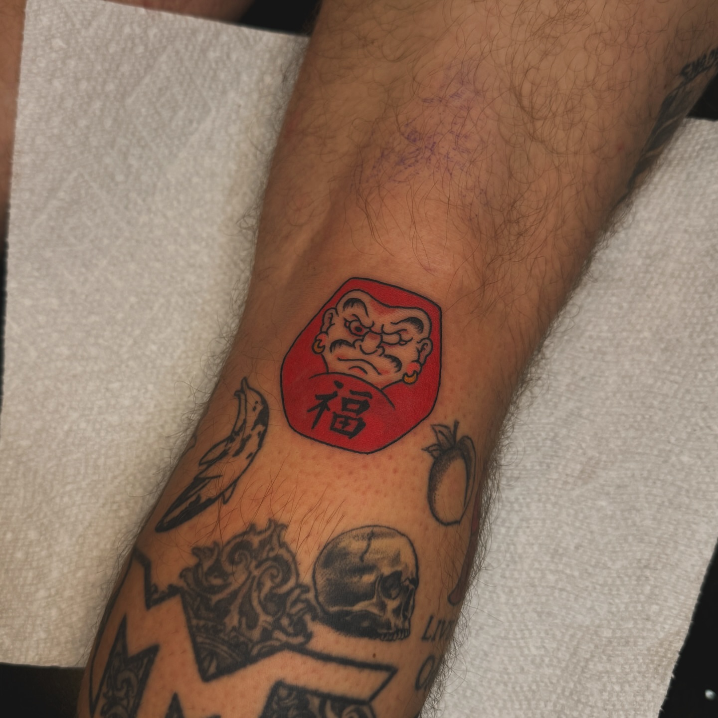 Red seal with face American traditional tattoo on the forearm by Liz Mercer ★ Tattooer - Raleigh NC