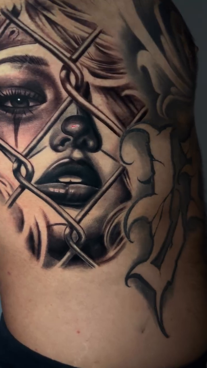 Woman behind chain link fence realism tattoo by inkzombi