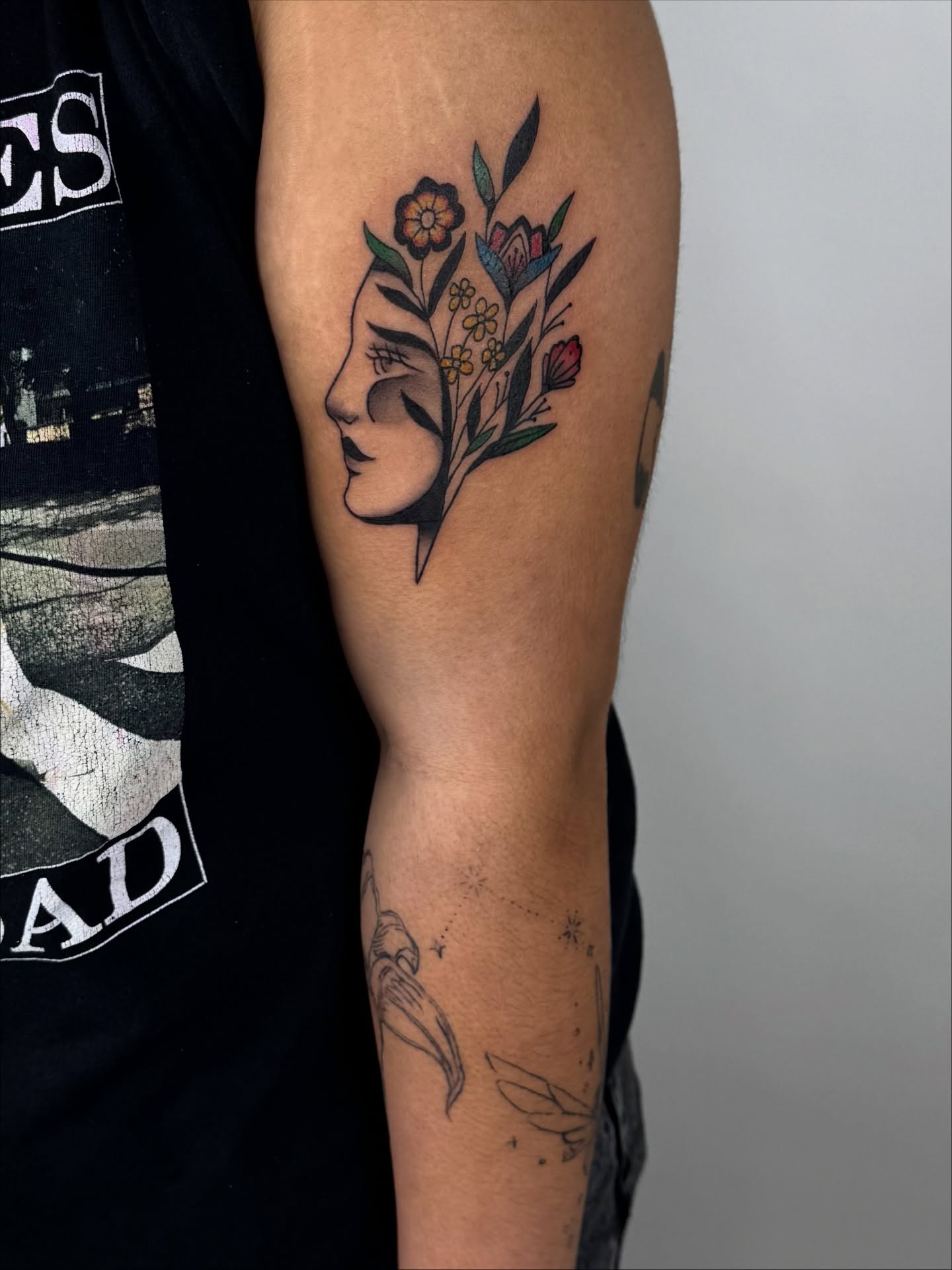 Floral profile neo-traditional tattoo on the forearm by sabina