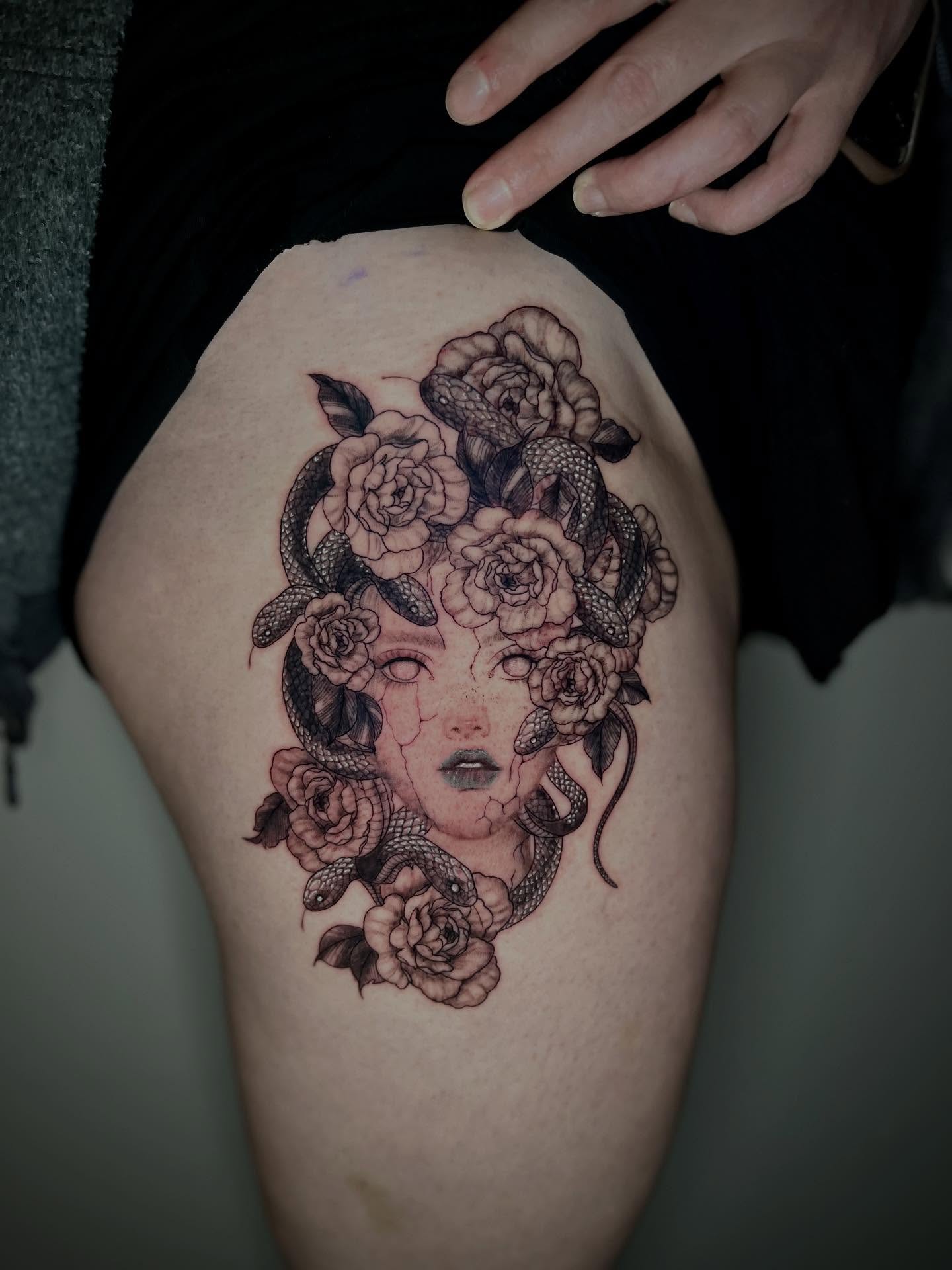 Woman with roses and snakes neo-traditional tattoo on the thigh by Cat girl tattoo