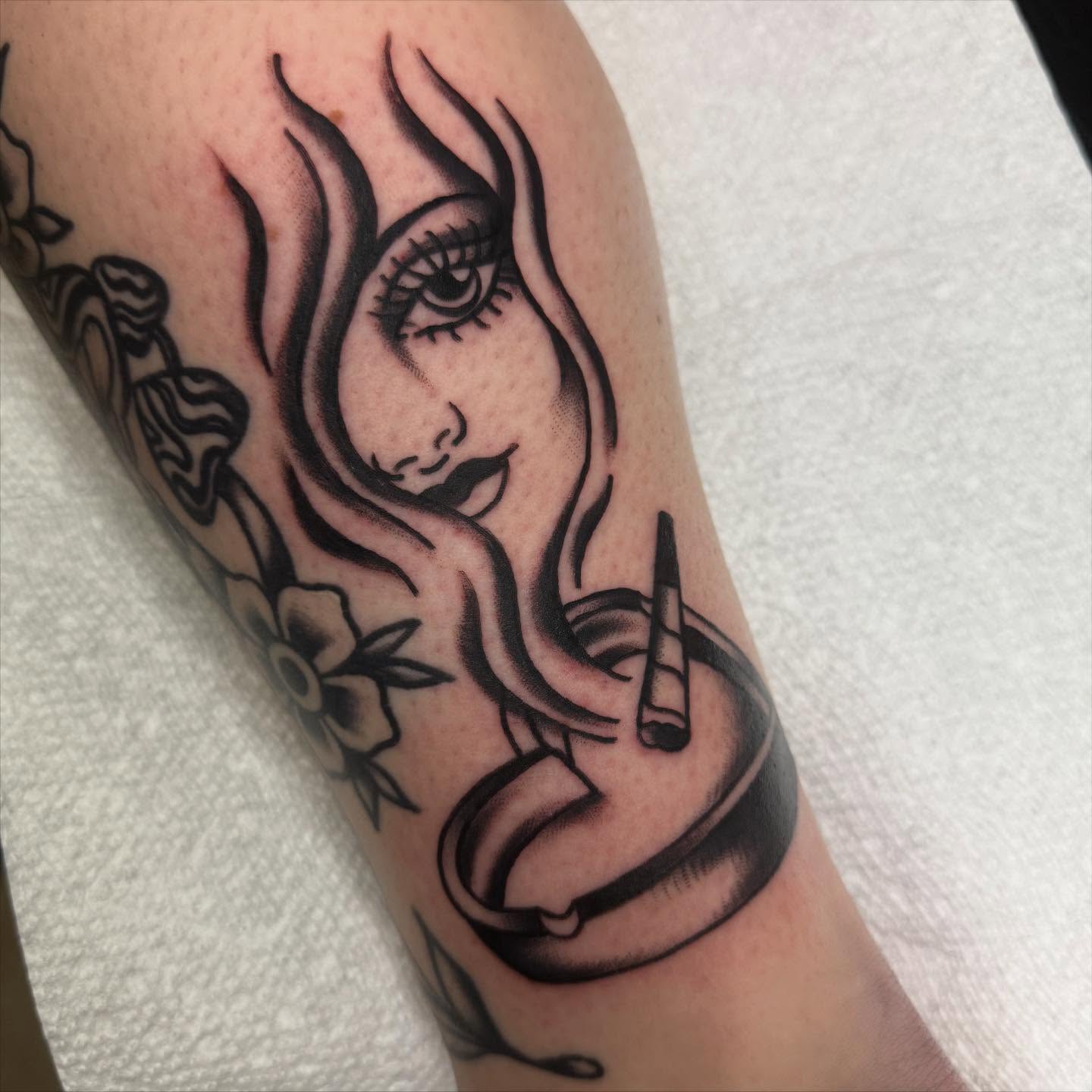 Woman smoking black and grey tattoo on the forearm by Shana