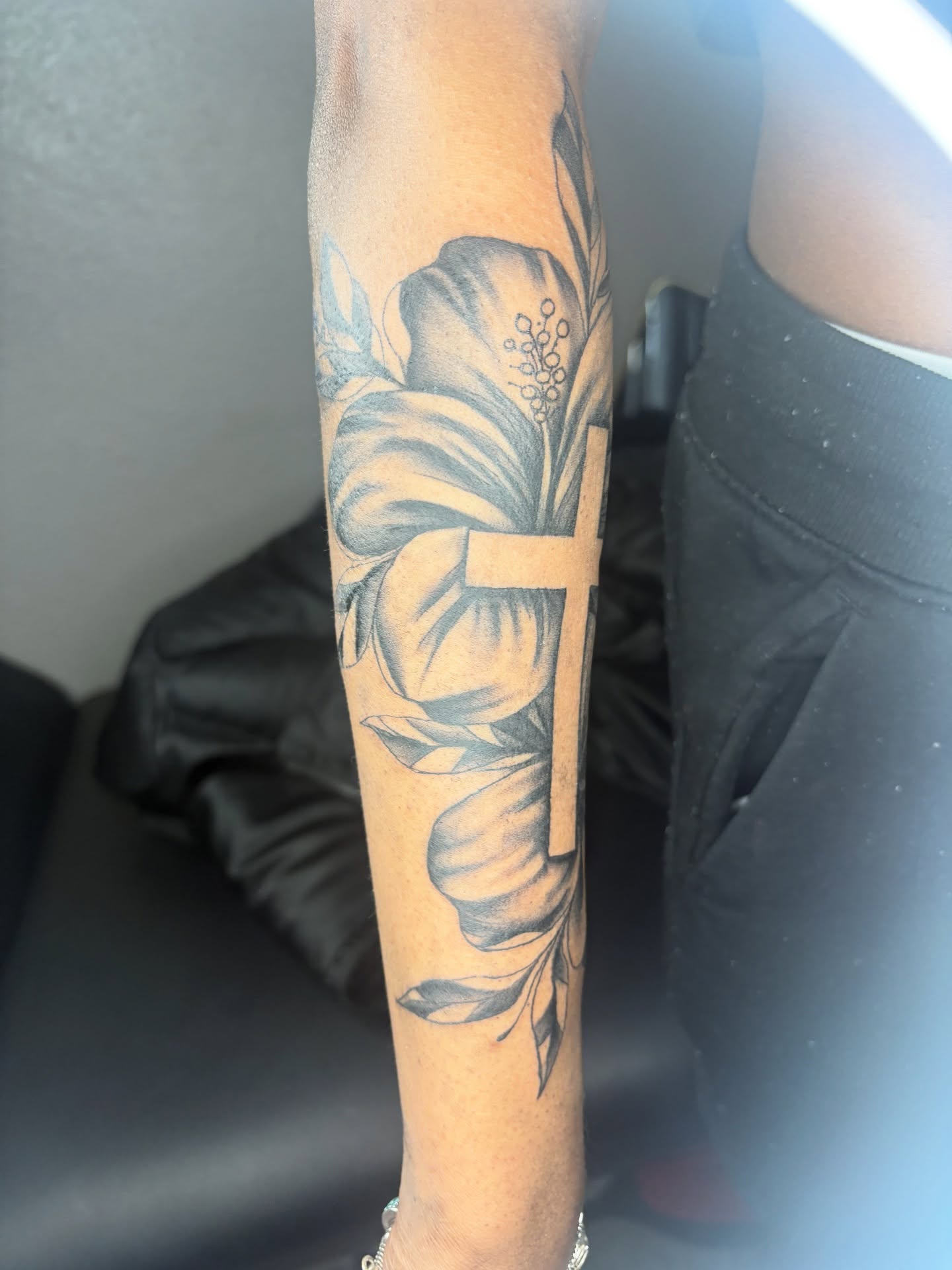 Flower black and grey tattoo on the forearm by Maleek Inkz