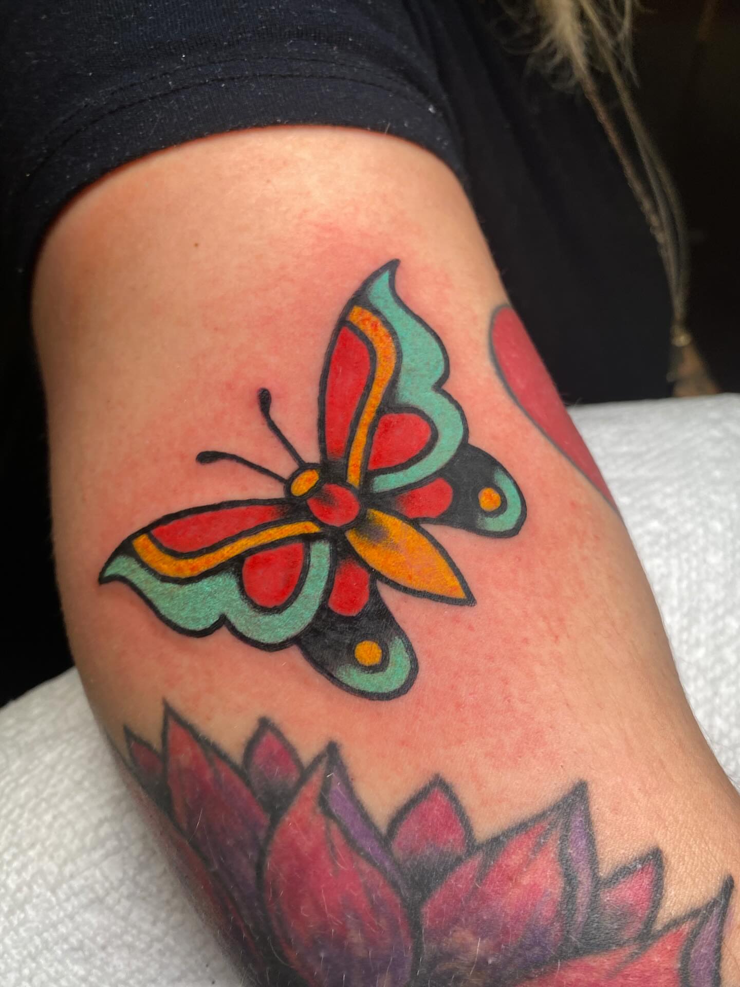 Butterfly American traditional tattoo on the forearm by @rubber_band_dan, San Francisco, California