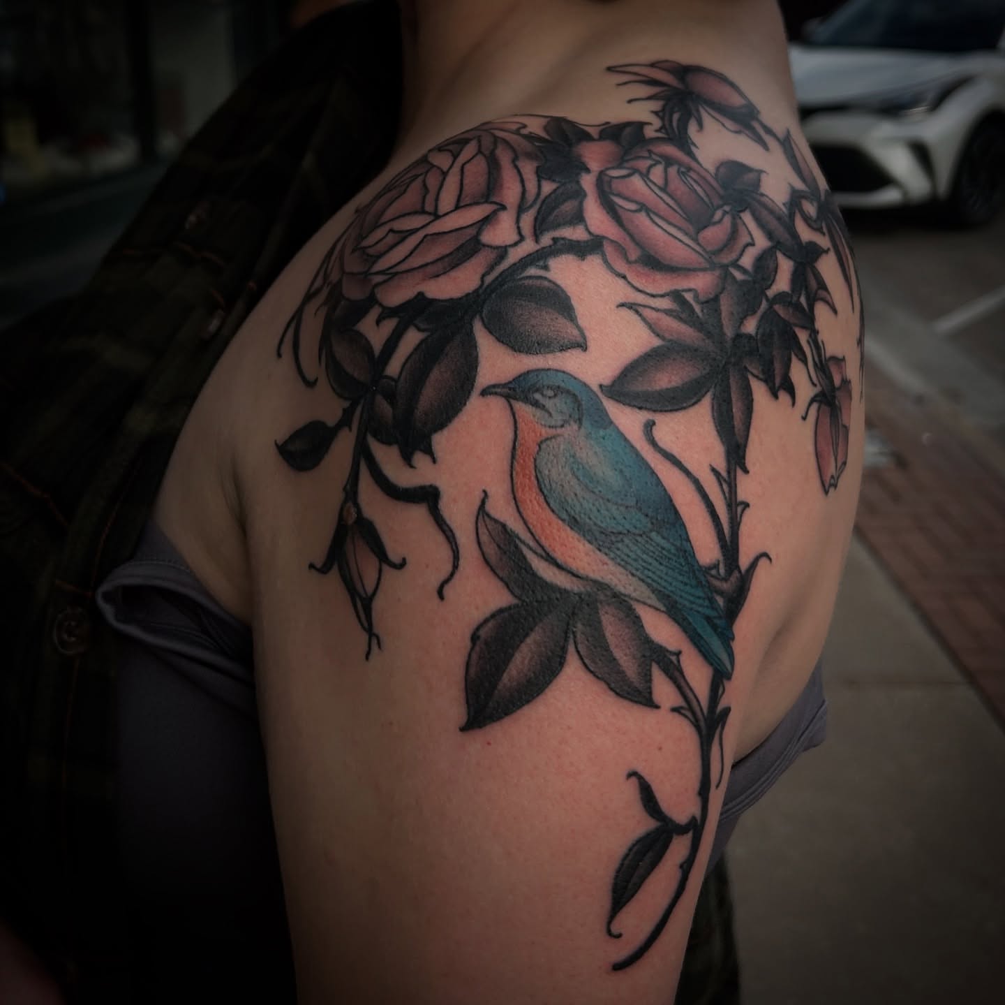 Bird and roses American traditional tattoo on the shoulder by ꧁𝙺𝚊𝚛𝚒𝚗𝚊꧂, Grinnell, Iowa