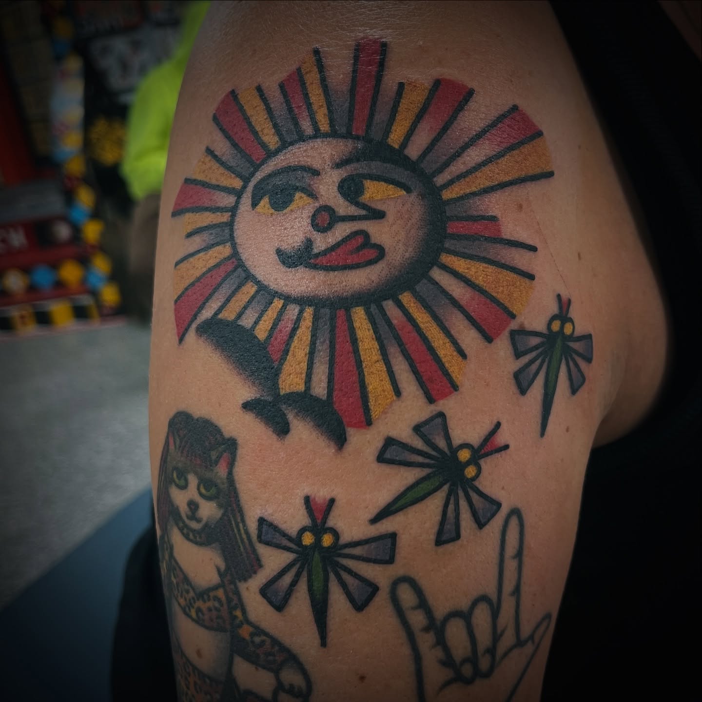 Sun and dragonflies American traditional tattoo on the upper arm by Deya Aven, Nashville, Tennessee
