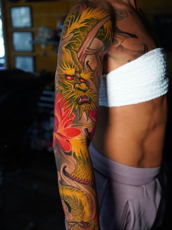 Dragon and lotus japanese irezumi tattoo on the upper arm by Grego Hernandez, Miami, Florida