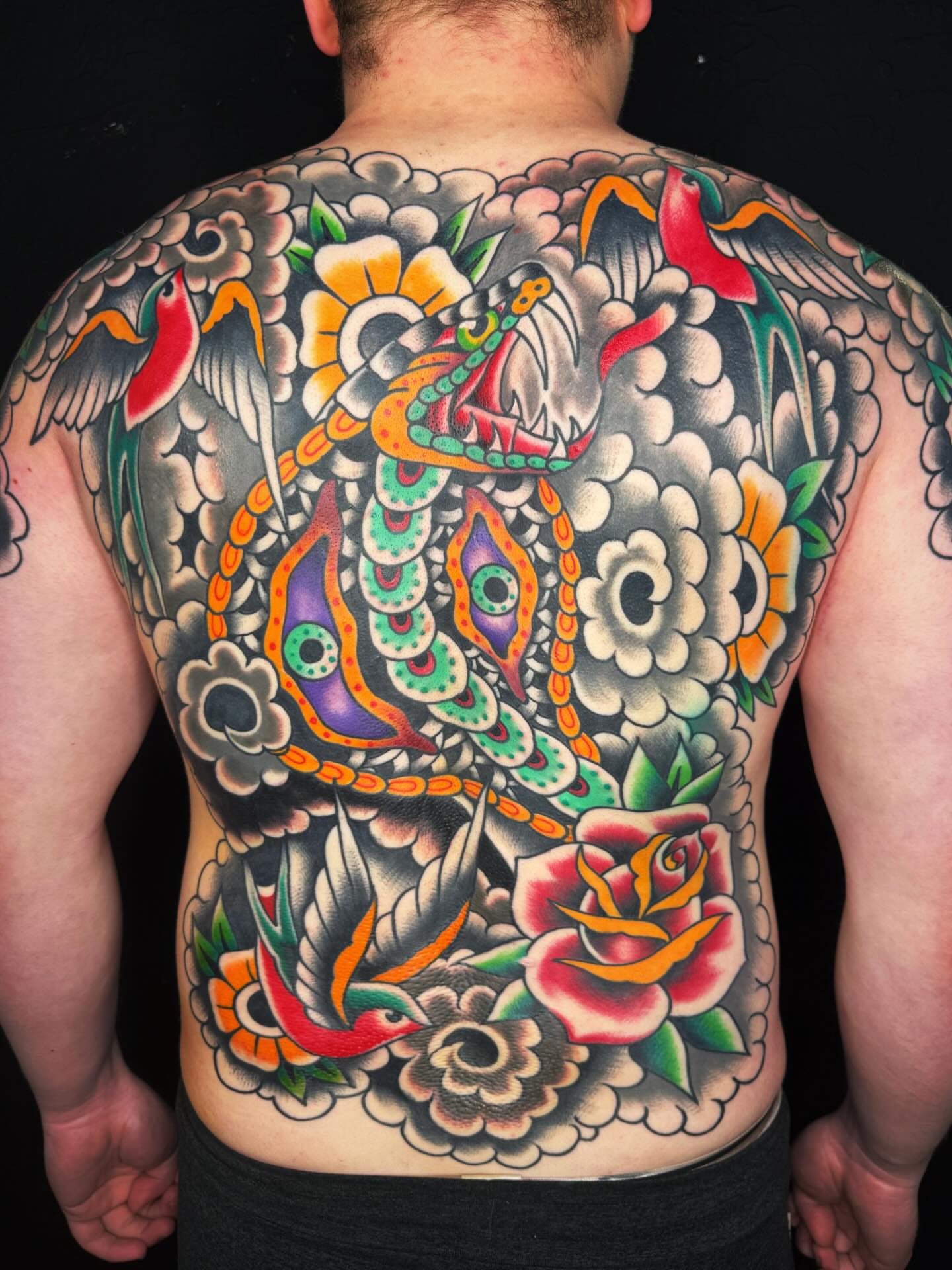 Snake and peony American traditional tattoo on the back by Mikey Sarratt