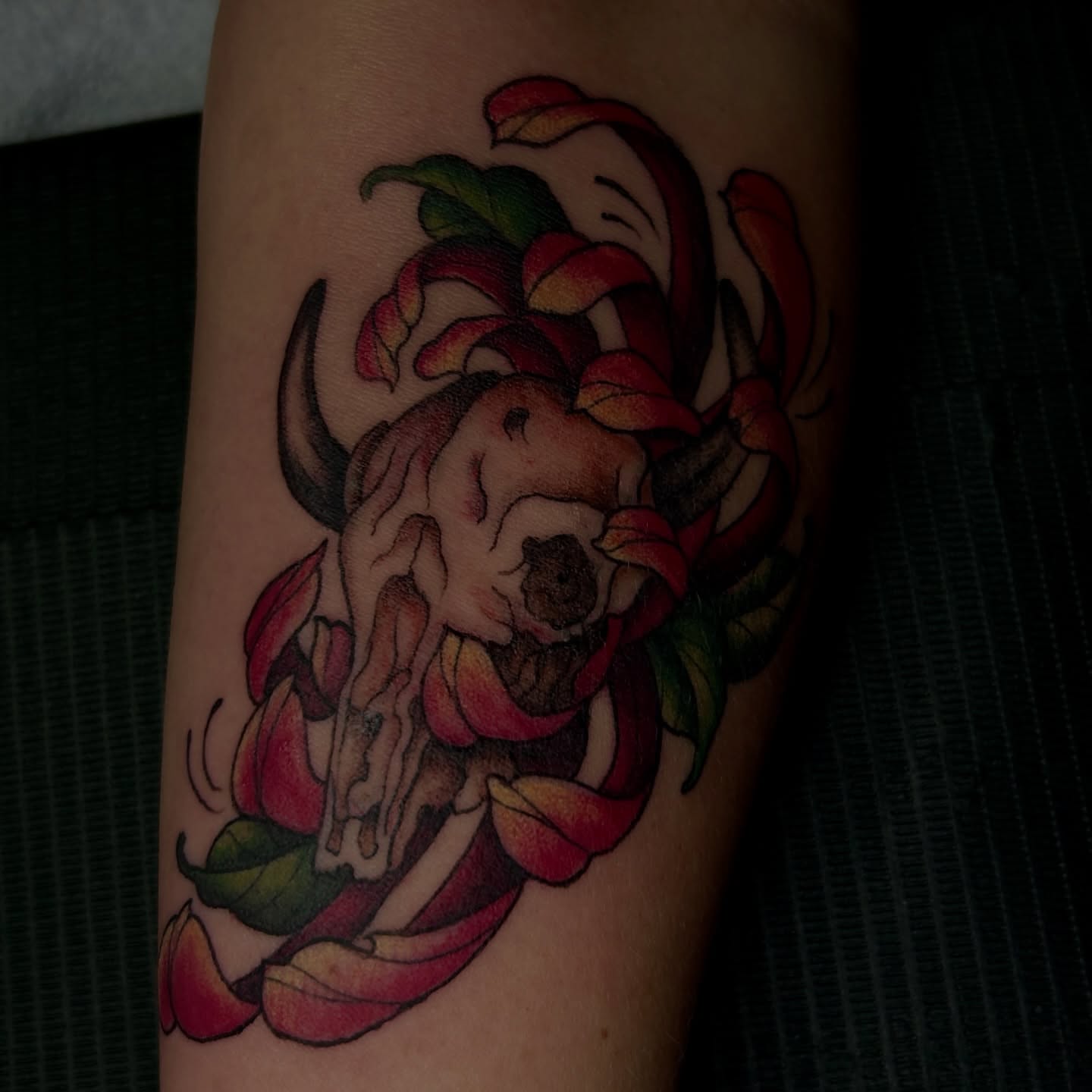 Bull skull and flowers American traditional tattoo on the forearm by Kat McCoy Guidera, Nashville, Tennessee