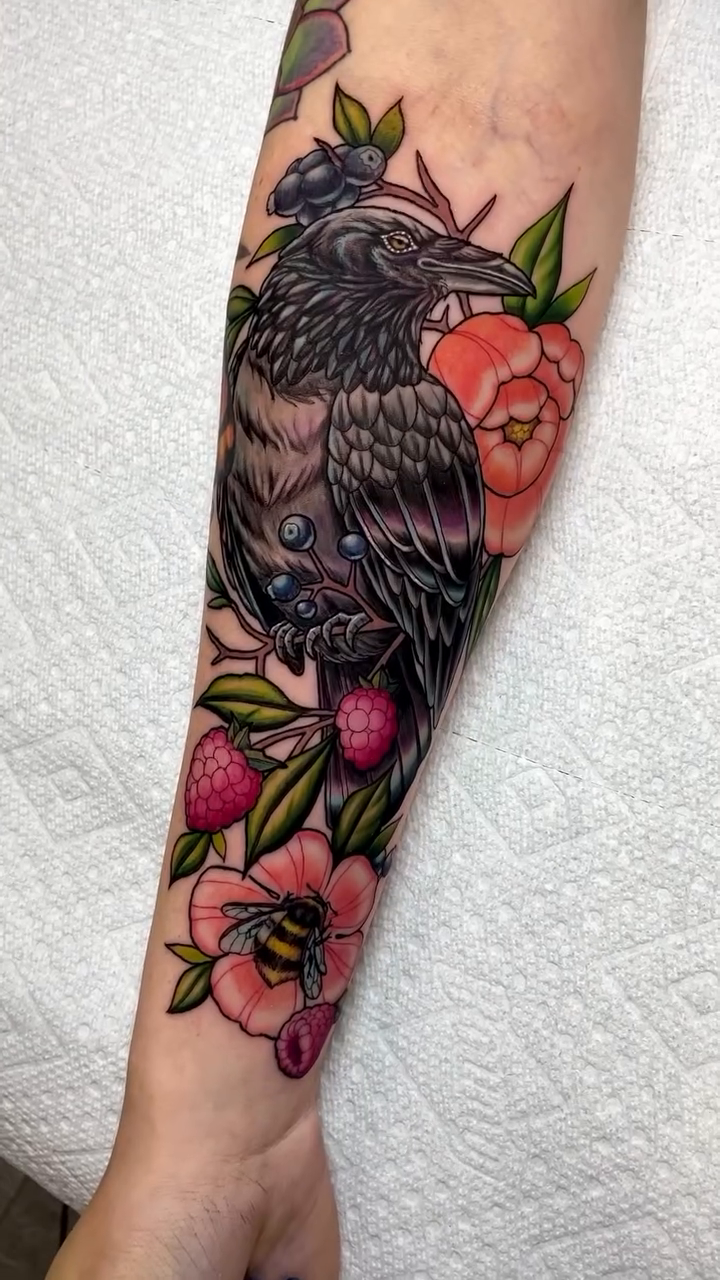 Raven with flowers and berries neo-traditional tattoo by Rick Elliott