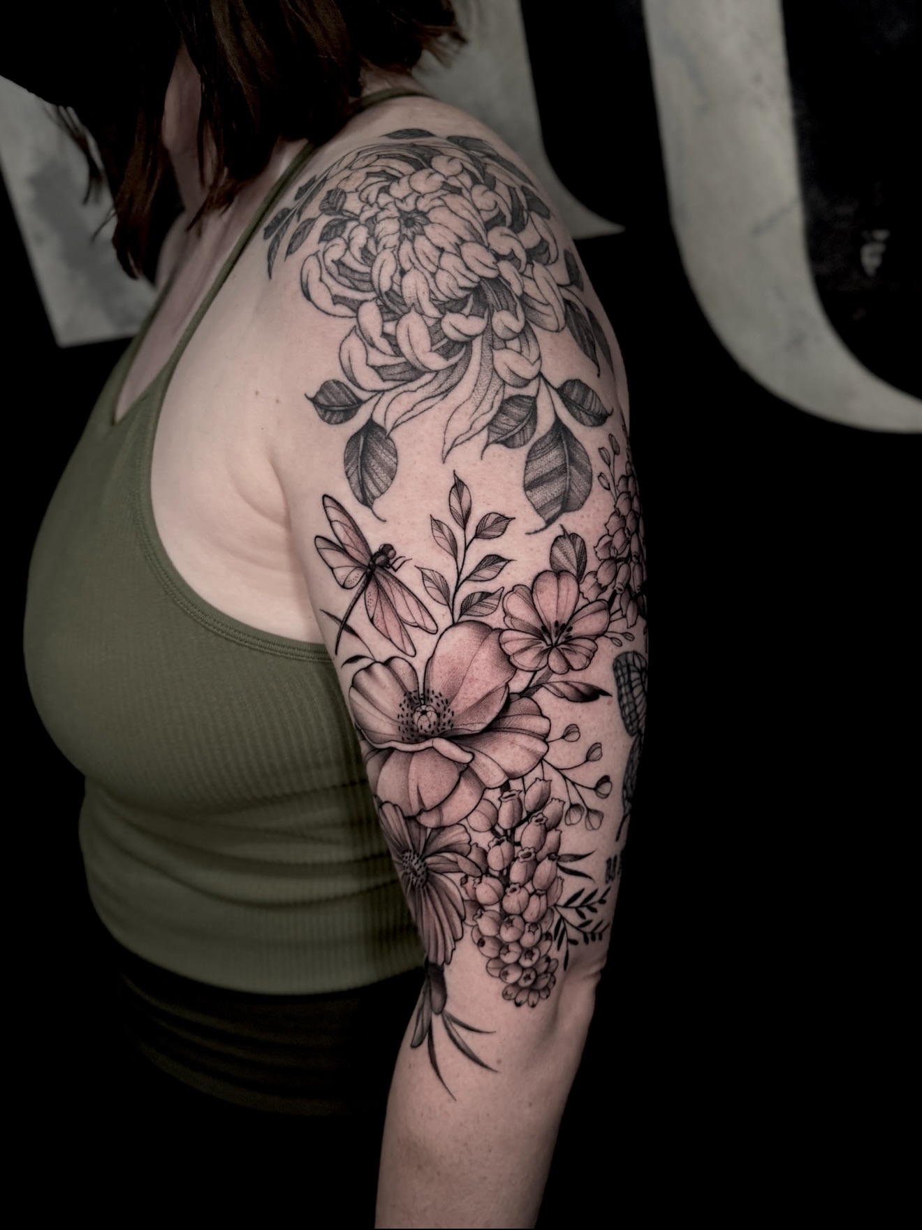Floral arrangement black and grey tattoo on the upper arm by Mel K Lockett - Nashville Tattoo Artist
