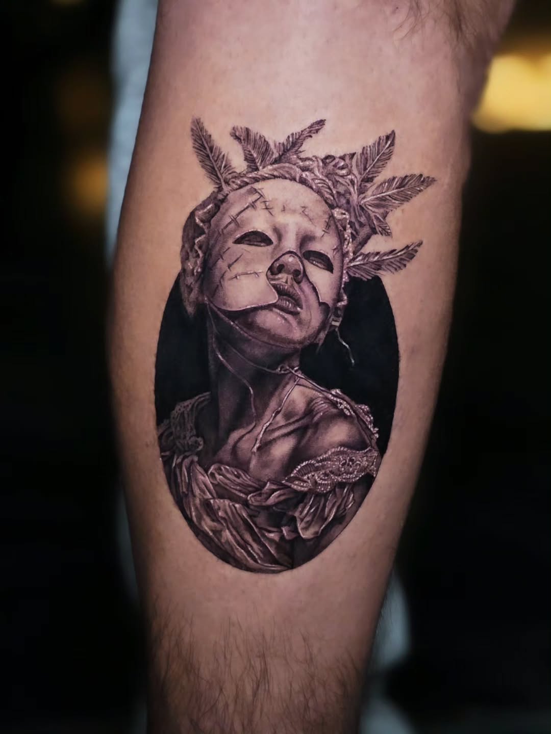 Cracked mask portrait surrealism tattoo on the forearm by Jake Barney