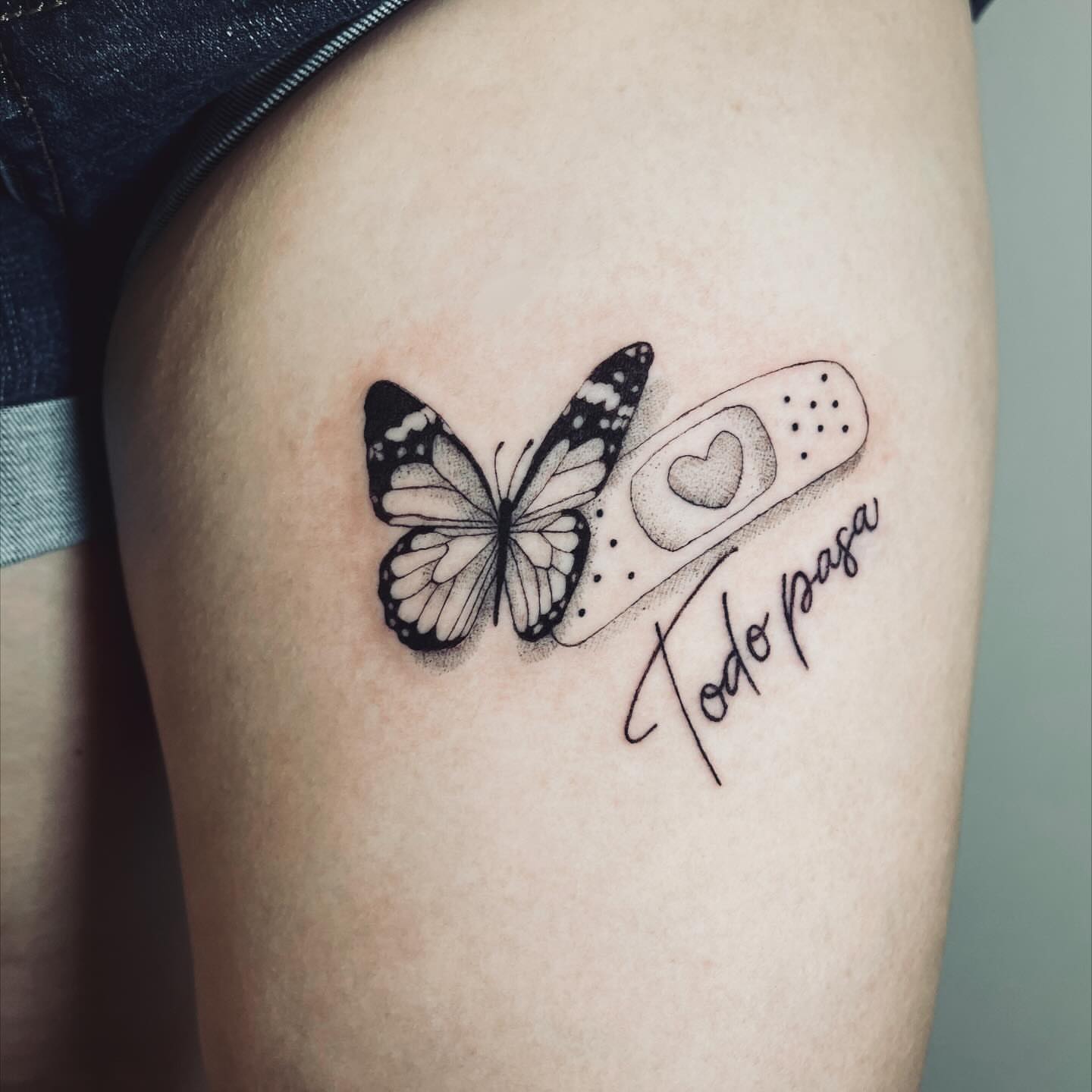 Butterfly and bandaid dotwork tattoo on the thigh by vivian