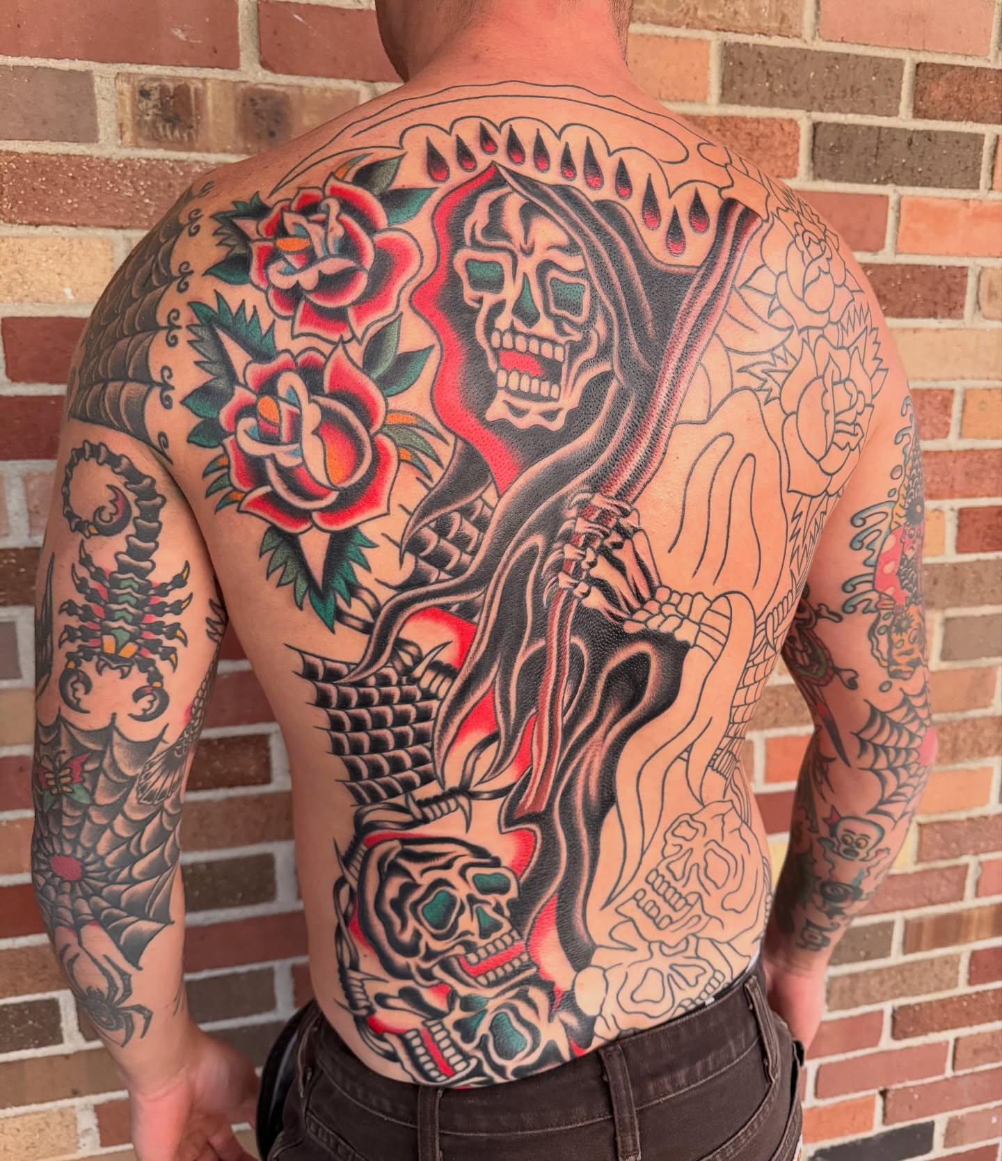 Skeleton and roses American traditional tattoo on the back by Nick Judkins Tattoo