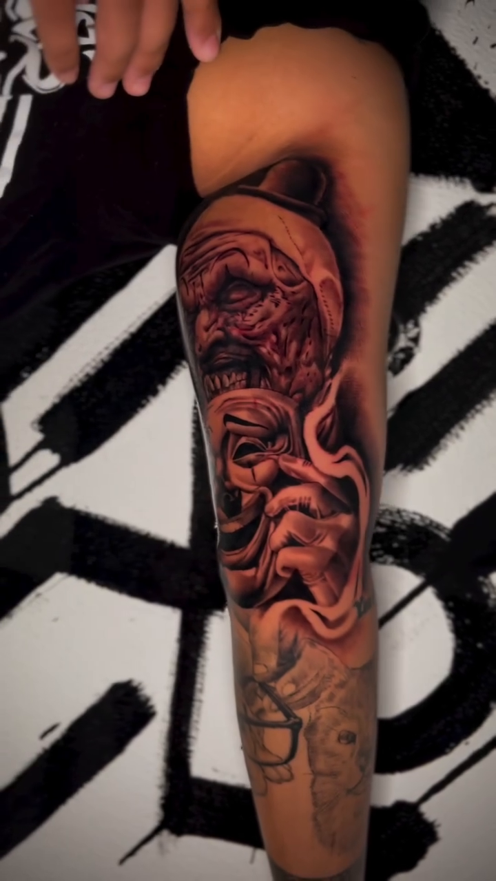 Tragedy and comedy masks realism tattoo on the forearm by Nick Andrade Las Vegas Tattoo Artist