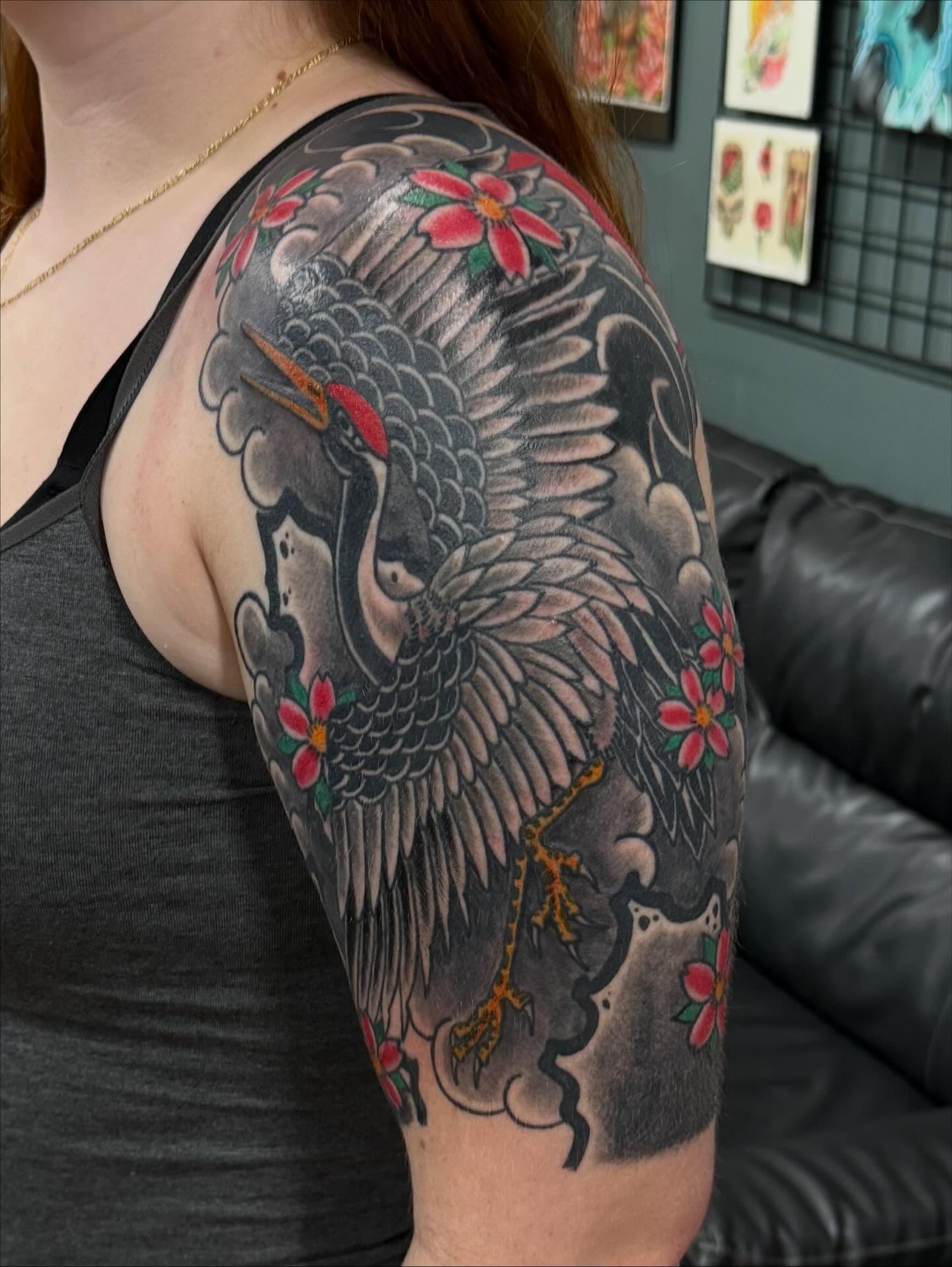 Crane and flowers japanese irezumi tattoo on the upper arm by Jackie