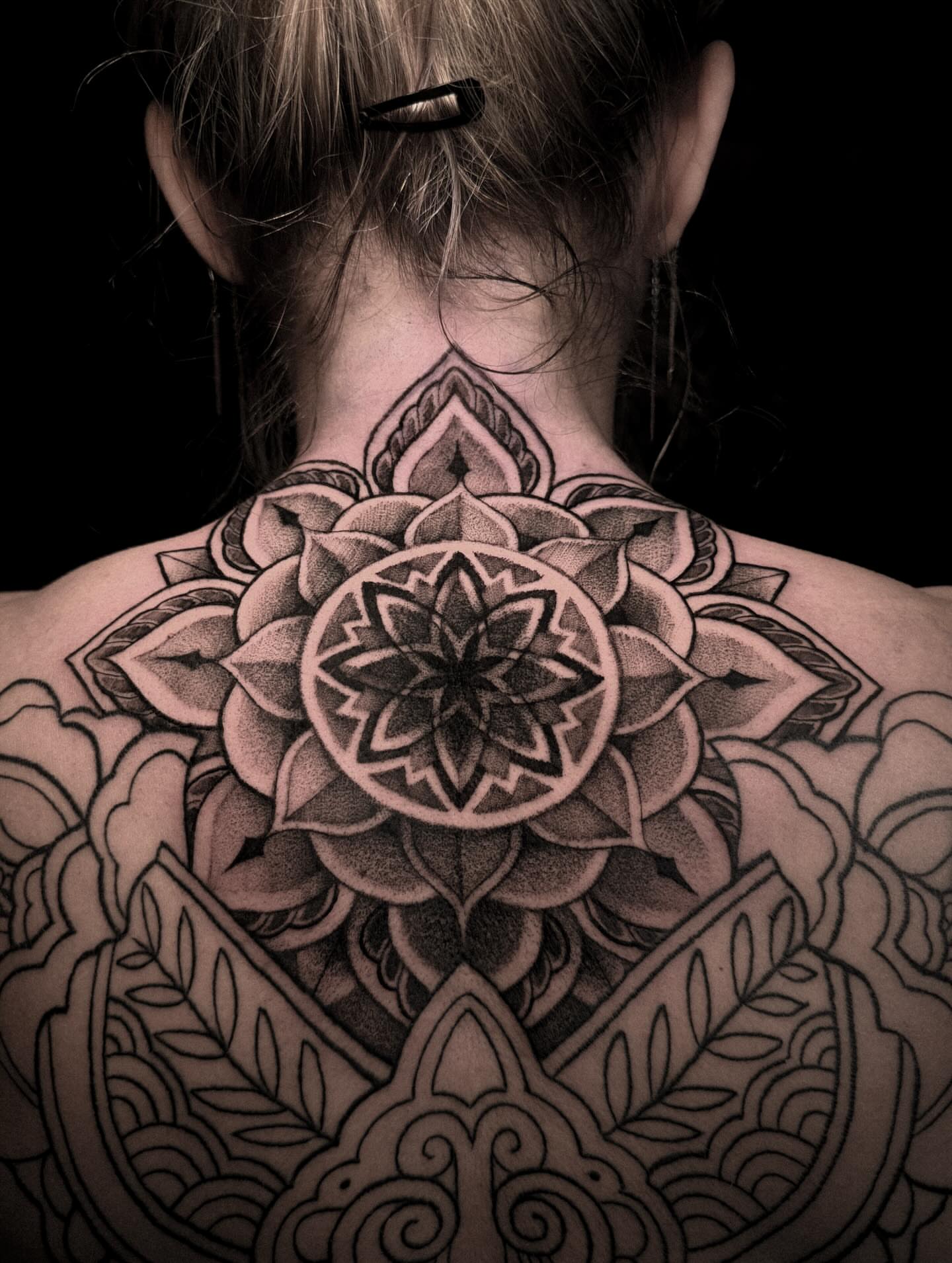 Lotus flower geometric tattoo on the back by La Hyene