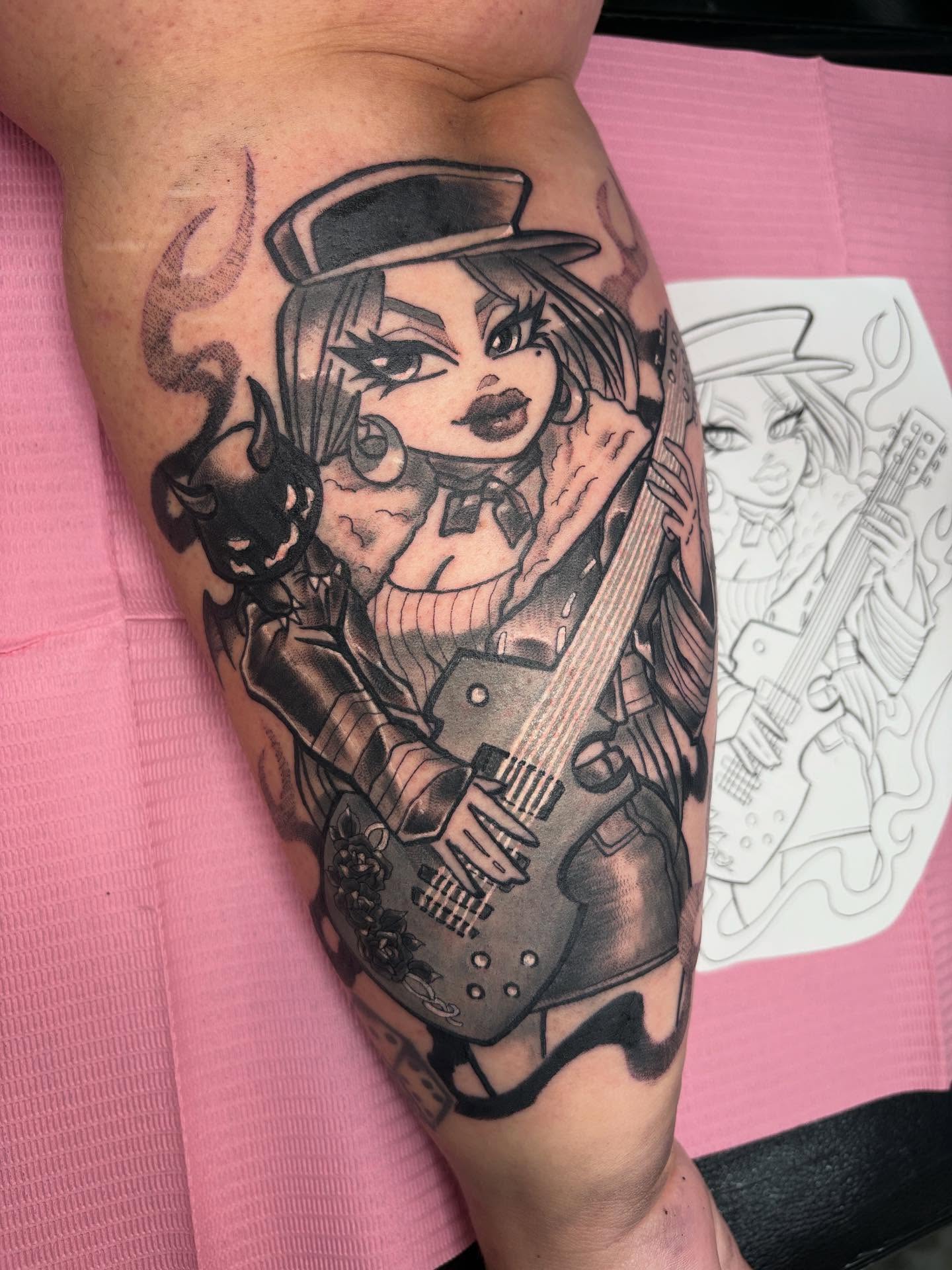 Anime character with guitar anime tattoo on the forearm by Gabby