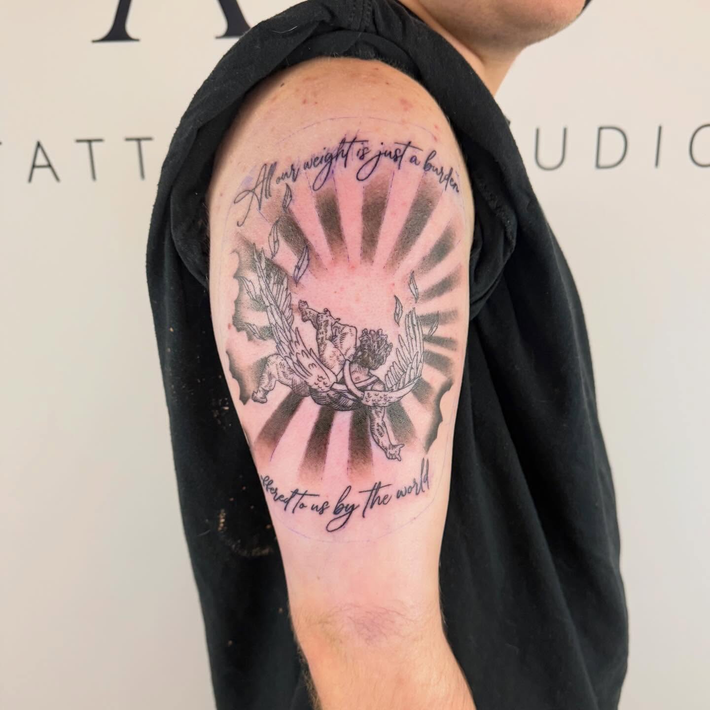 Prayer hands and sunburst black and grey tattoo on the shoulder by Paul Calhoun Tattoos, Englewood, Ohio
