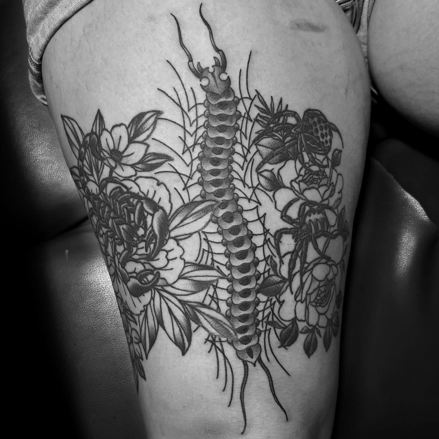 Centipede and flowers dotwork tattoo on the thigh by @sloanxkettering
