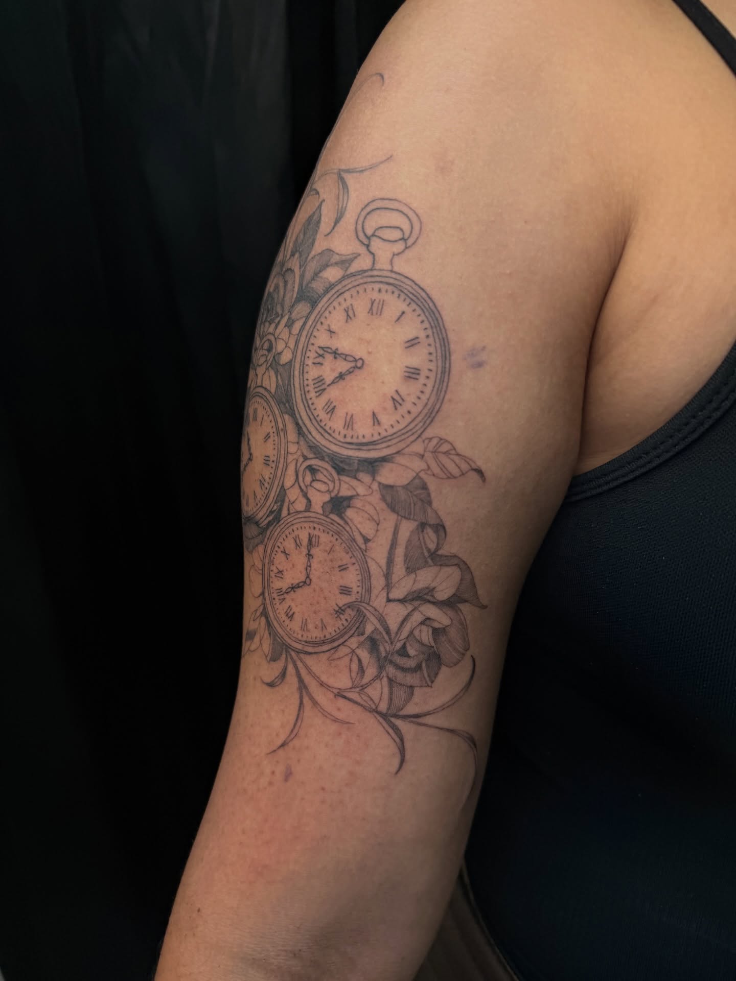 Clocks and flowers black and grey tattoo on the forearm by Elijah Cosme, Miami, Florida