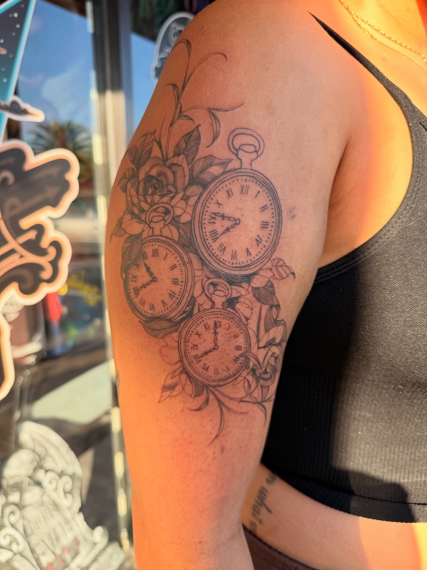 Pocket watches black and grey tattoo on the upper arm by Elijah Cosme, Miami, Florida