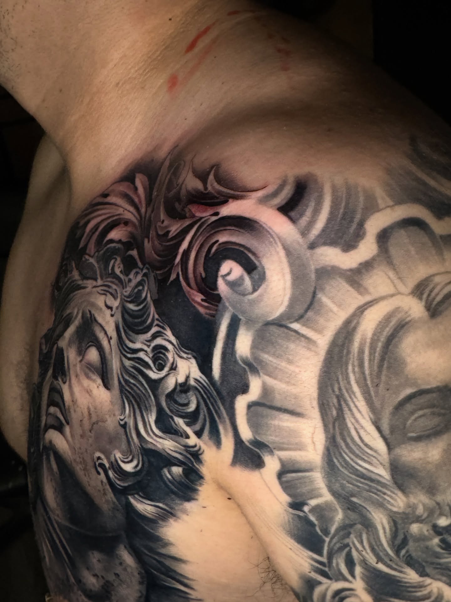 Waves and faces realism tattoo on the back by TATTOOS by Elvis Ramos - California tattoo