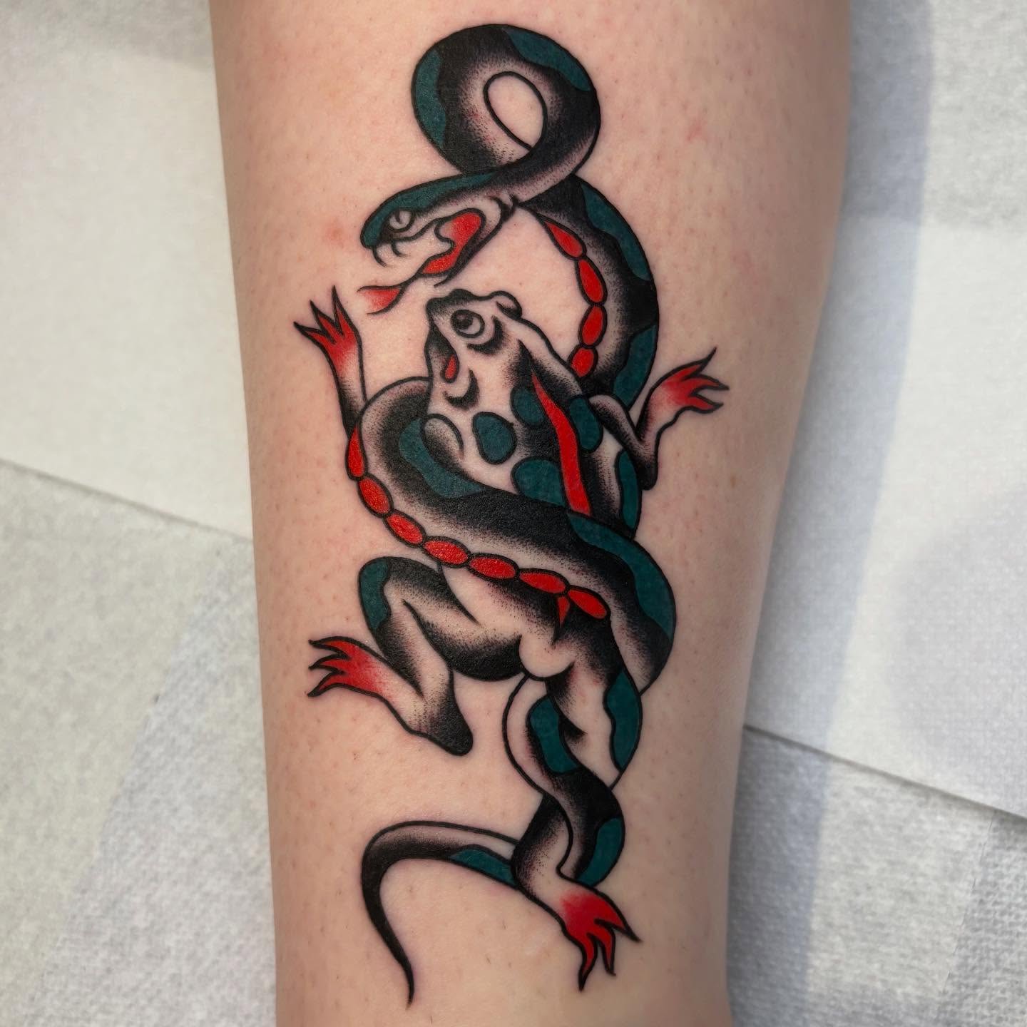 Frog and snake American traditional tattoo on the forearm by Texas Jonah
