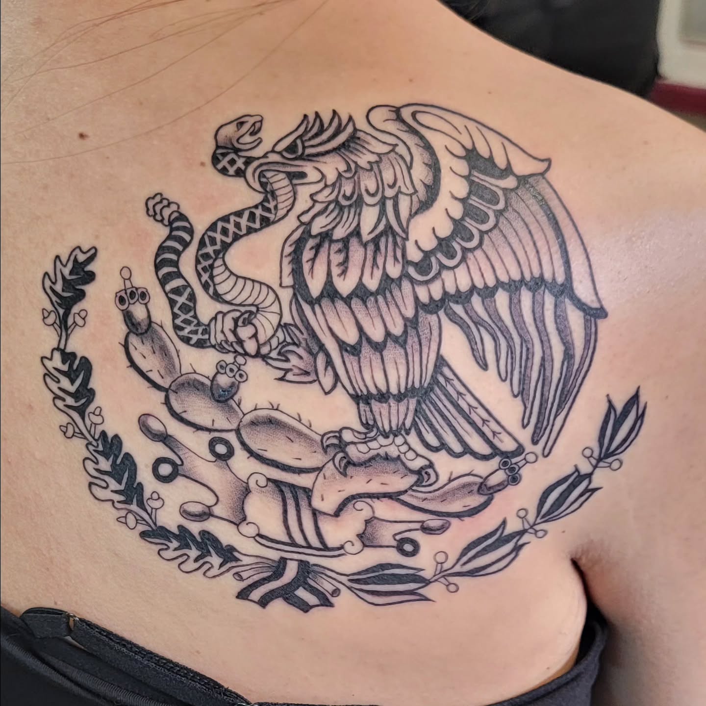 Mexican coat of arms tattoo on the back by Hatchetfoot Art
