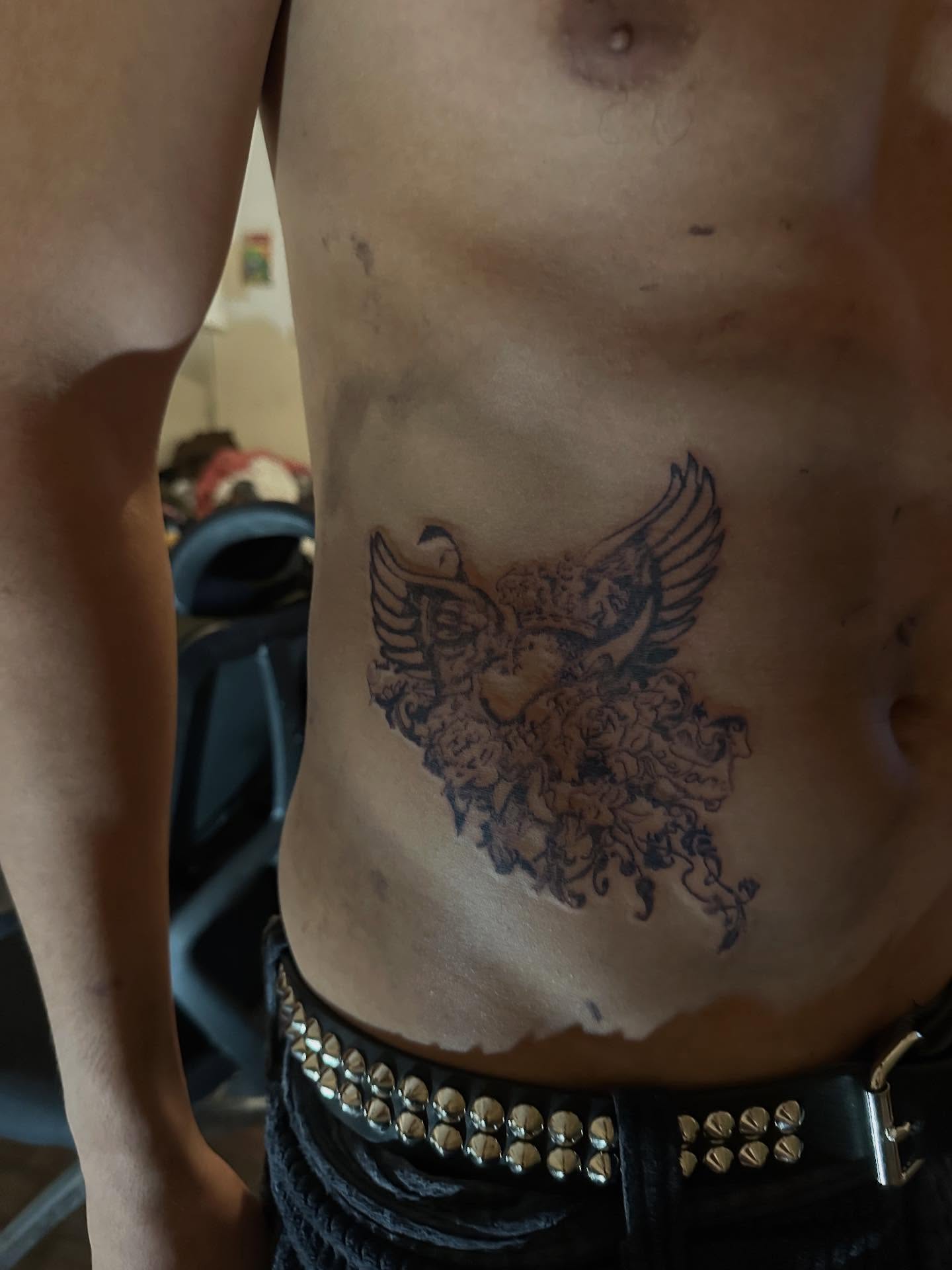 Floral phoenix black and grey tattoo on the torso by Swag Originator