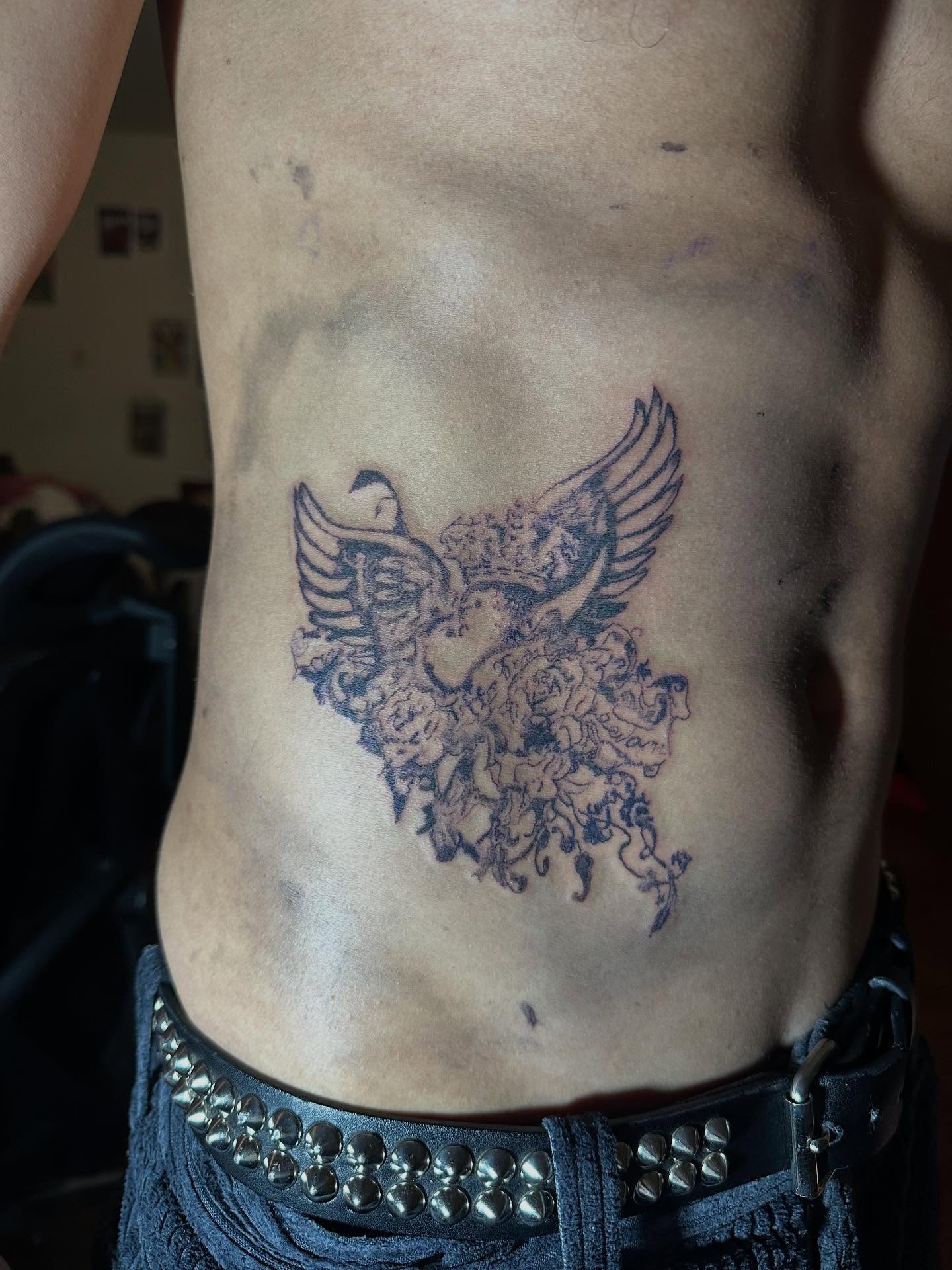 Floral phoenix black and grey tattoo on the ribs by Swag Originator
