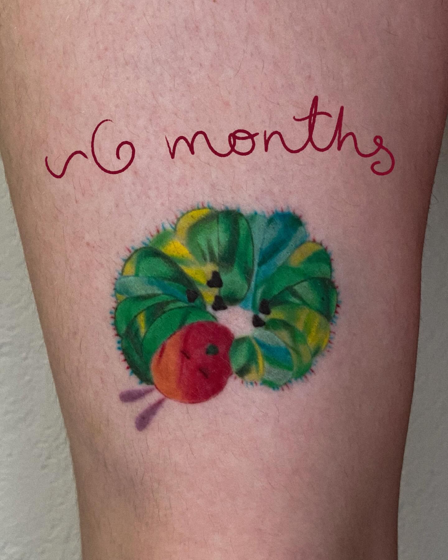 Worm and apple new school tattoo on the forearm by Autumn