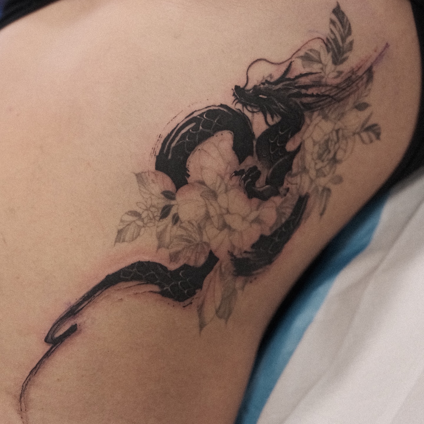 Dragon and flowers realism tattoo on the thigh by Perth tattoo 류, Perth, Western Australia