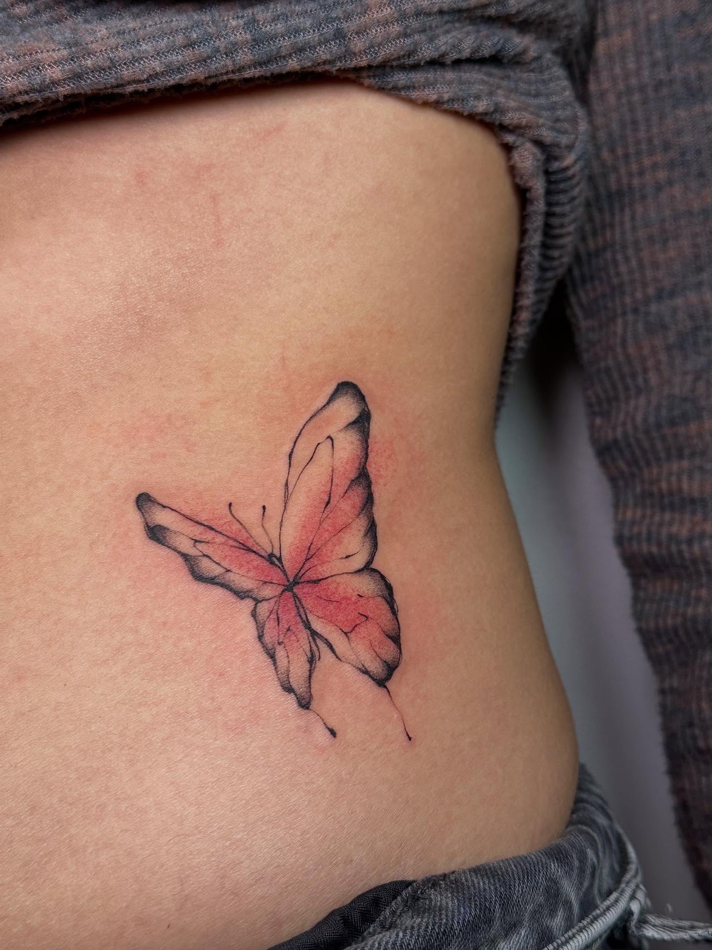 Butterfly watercolor tattoo on the ribs by Tomato