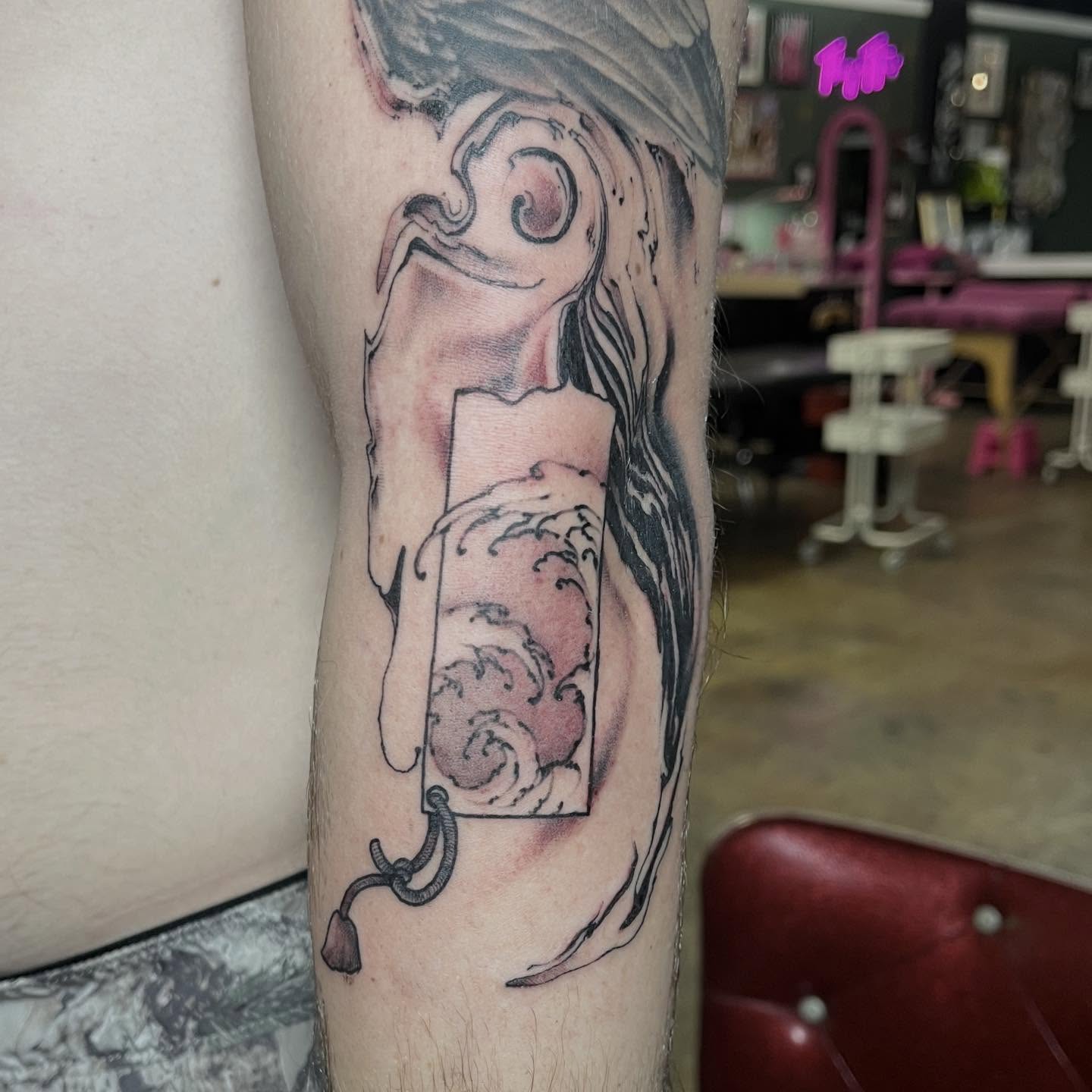Scroll with waves realism tattoo on the forearm by Dallas Davis