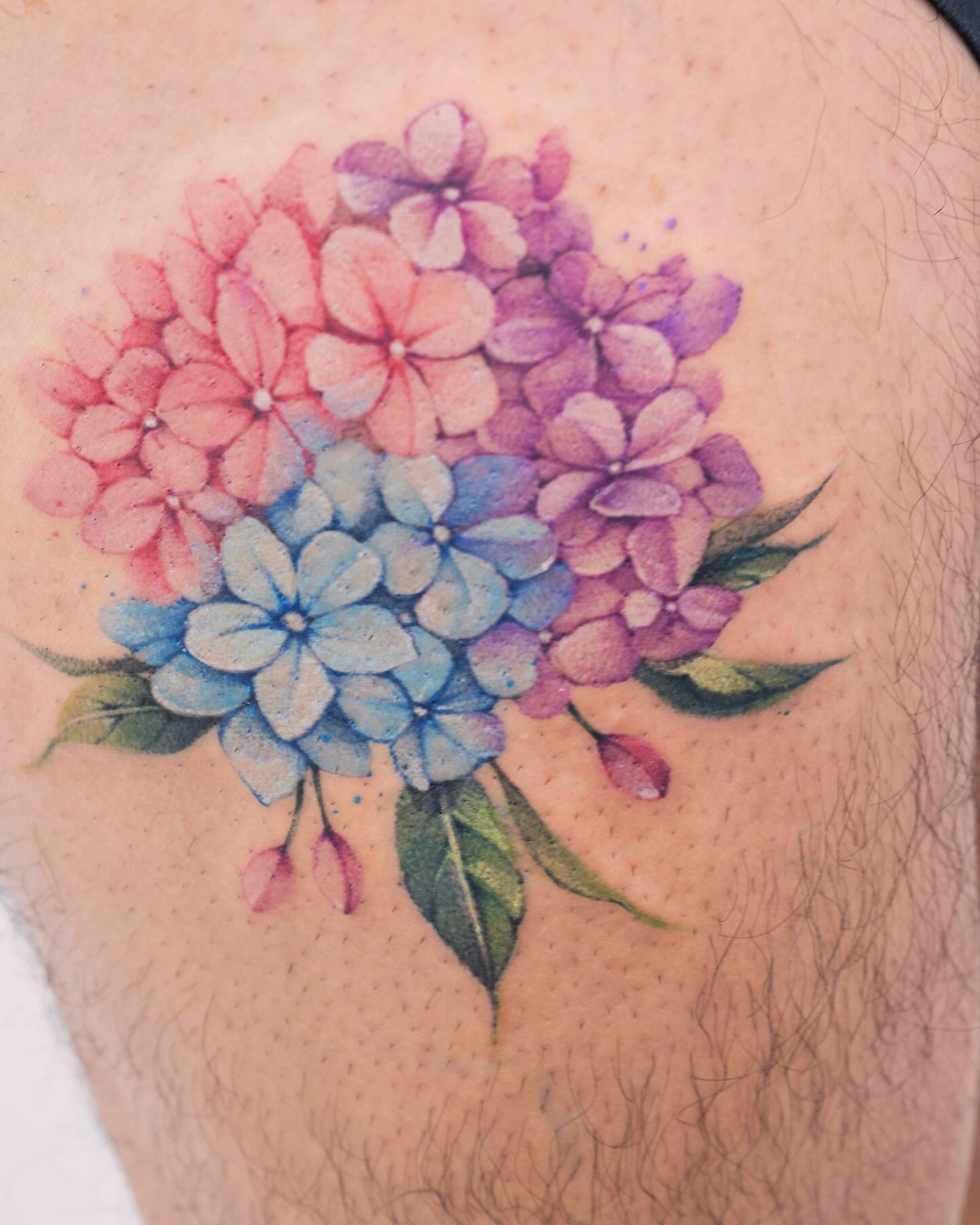 Hydrangea bouquet watercolor tattoo on the thigh by Tattooist hea