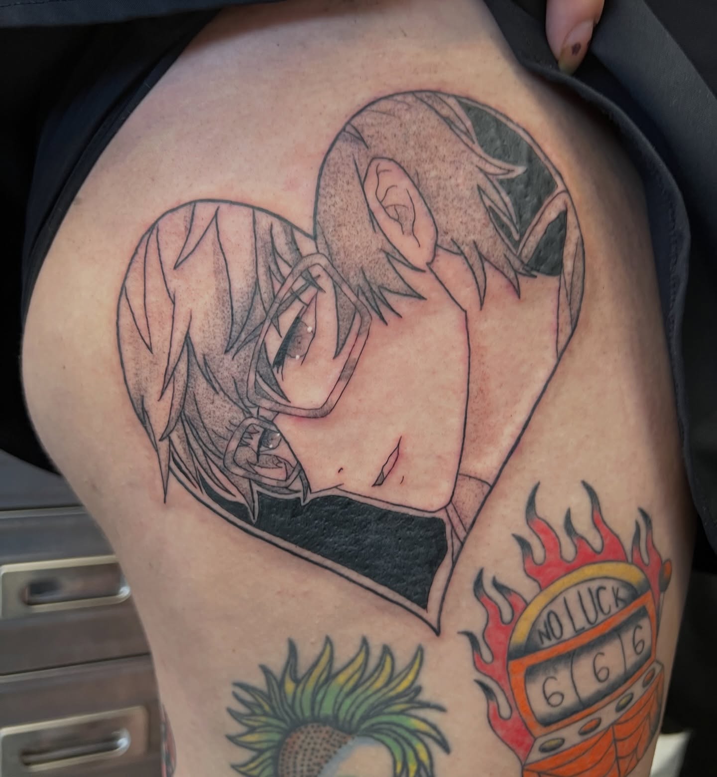 Anime couple anime tattoo on the thigh by Leslie Paskoff