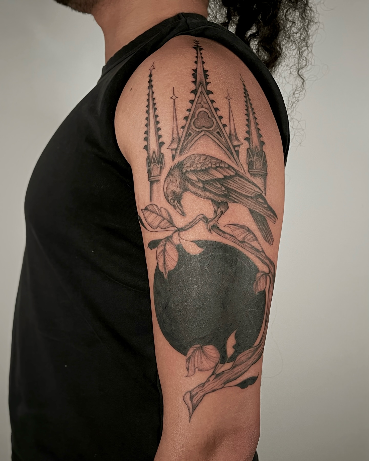 Crow and apple realism tattoo on the forearm by Mikayla Sue
