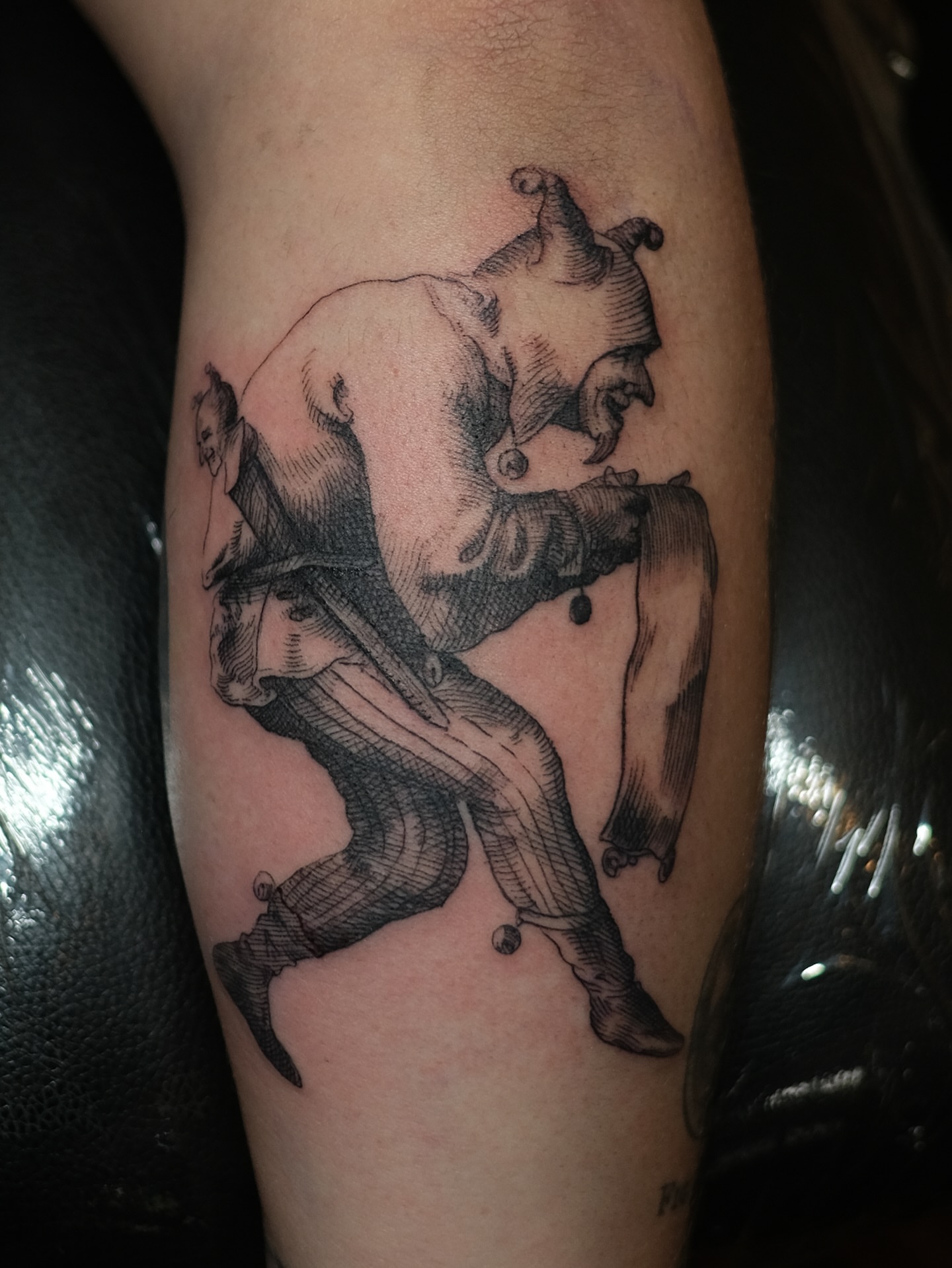 Jester black and grey tattoo on the forearm by Zanereti