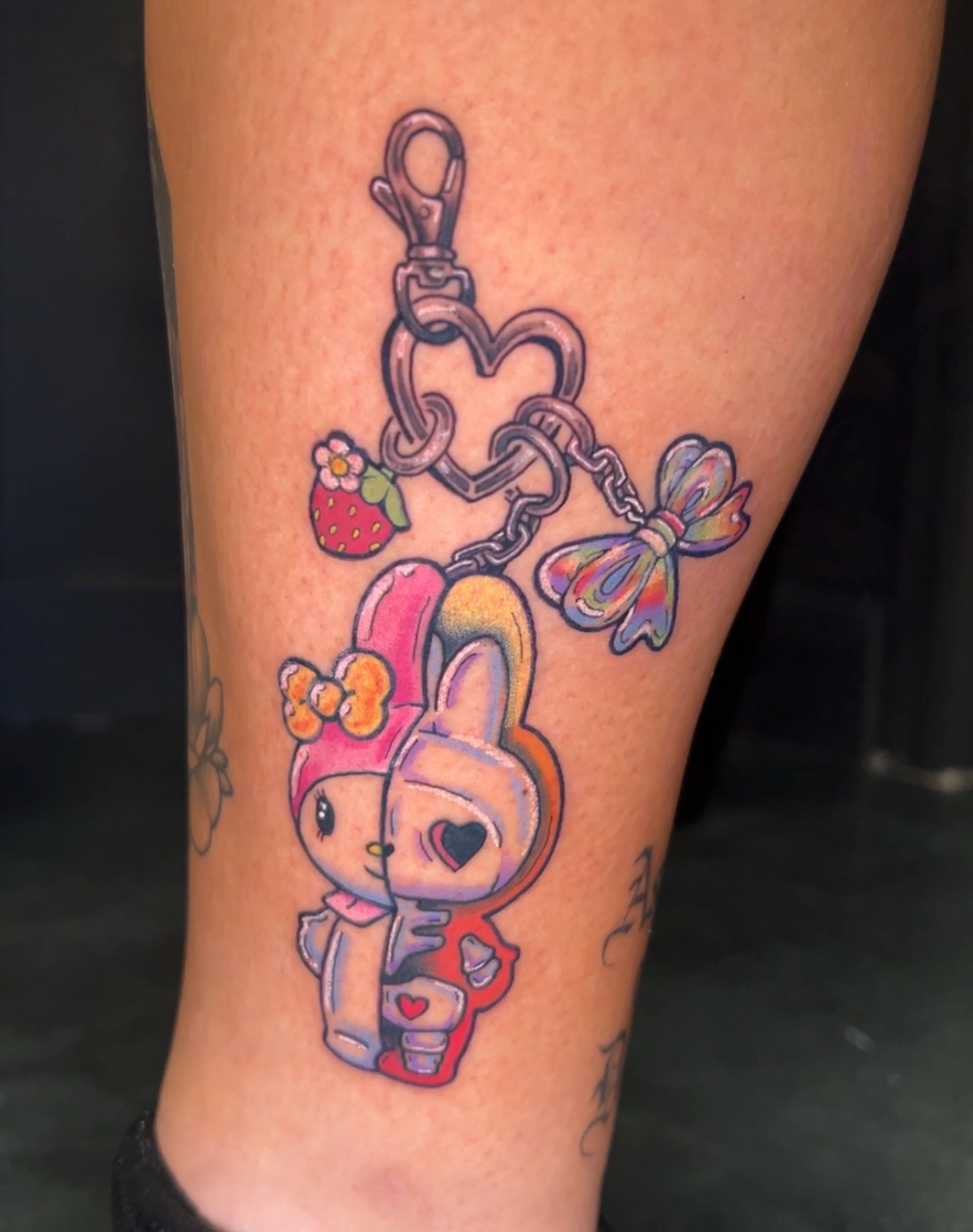 Kawaii character with heart new school tattoo on the leg by Mickey