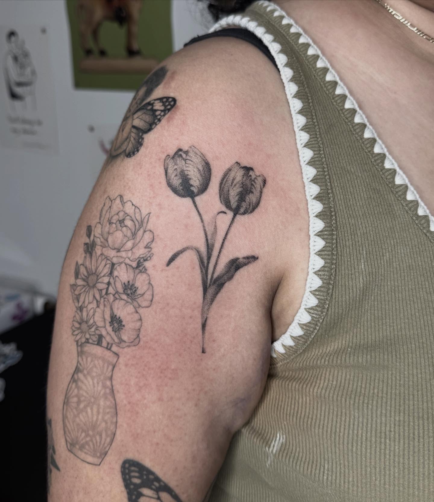 Flowers and vase black and grey tattoo on the upper arm by 🗡Addie Kat🗡