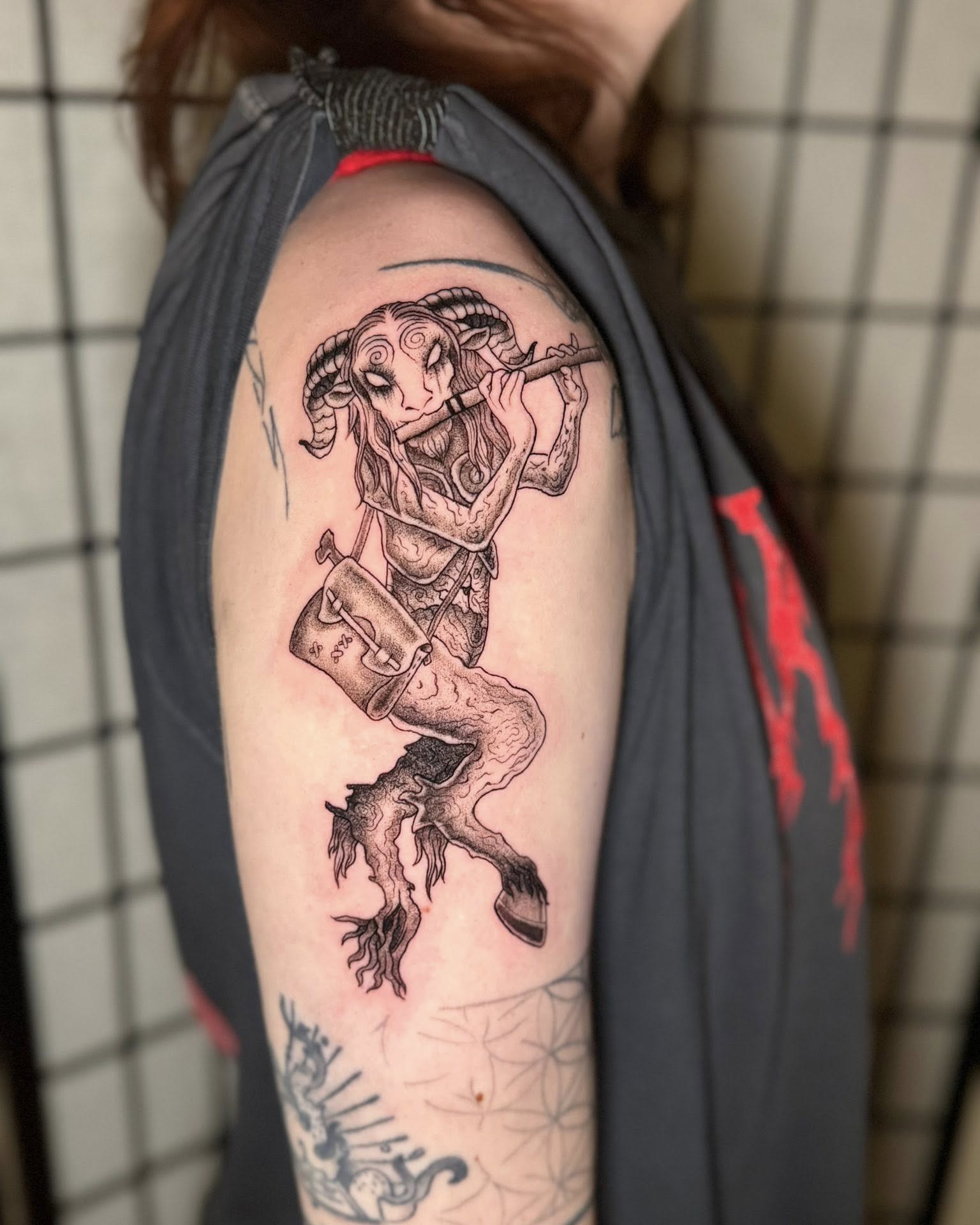 Ram playing flute realism tattoo on the shoulder by Austin Poliszuk, Minneapolis, Minnesota