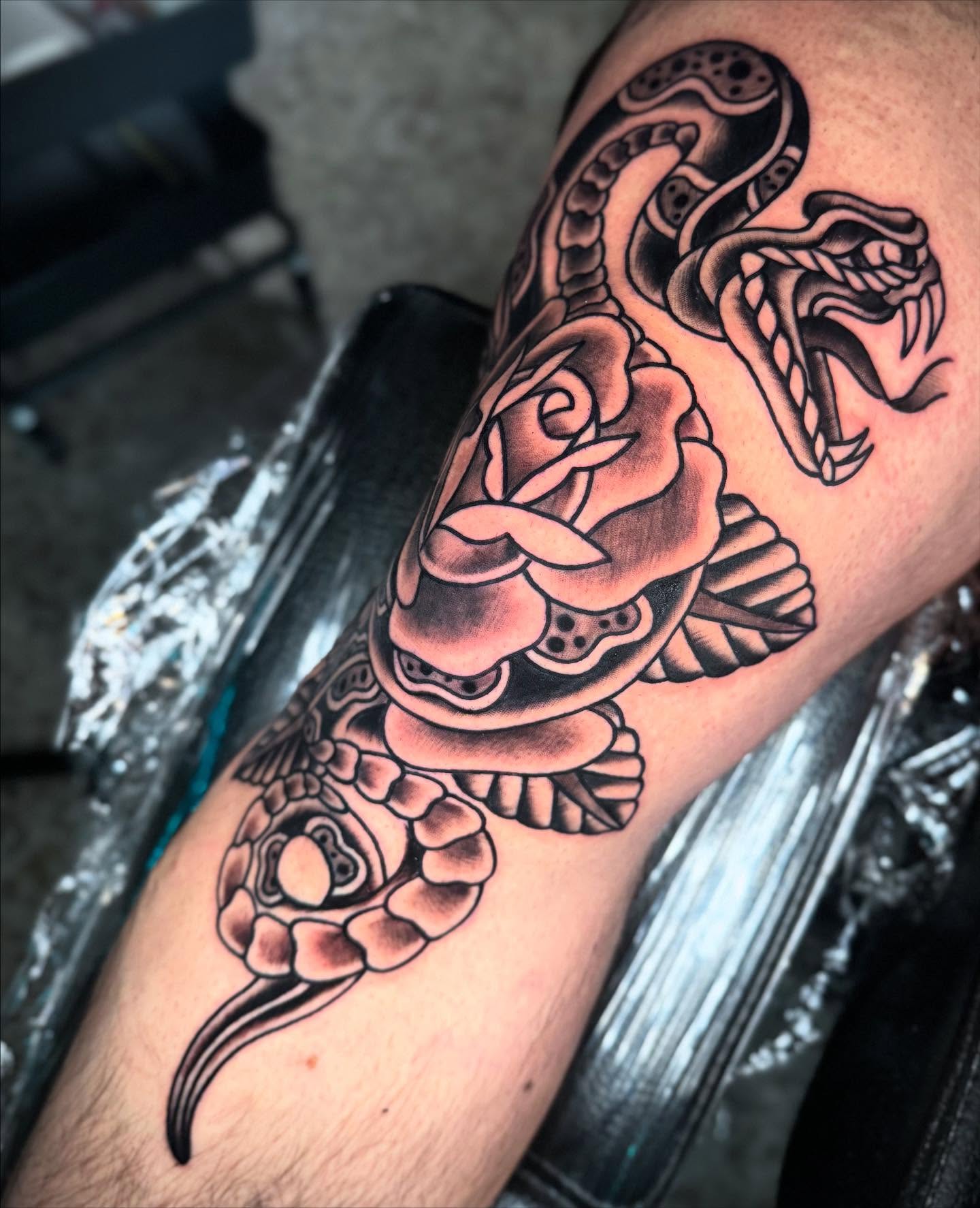 Snake and rose geometric tattoo on the forearm by Graham Edward Vogel