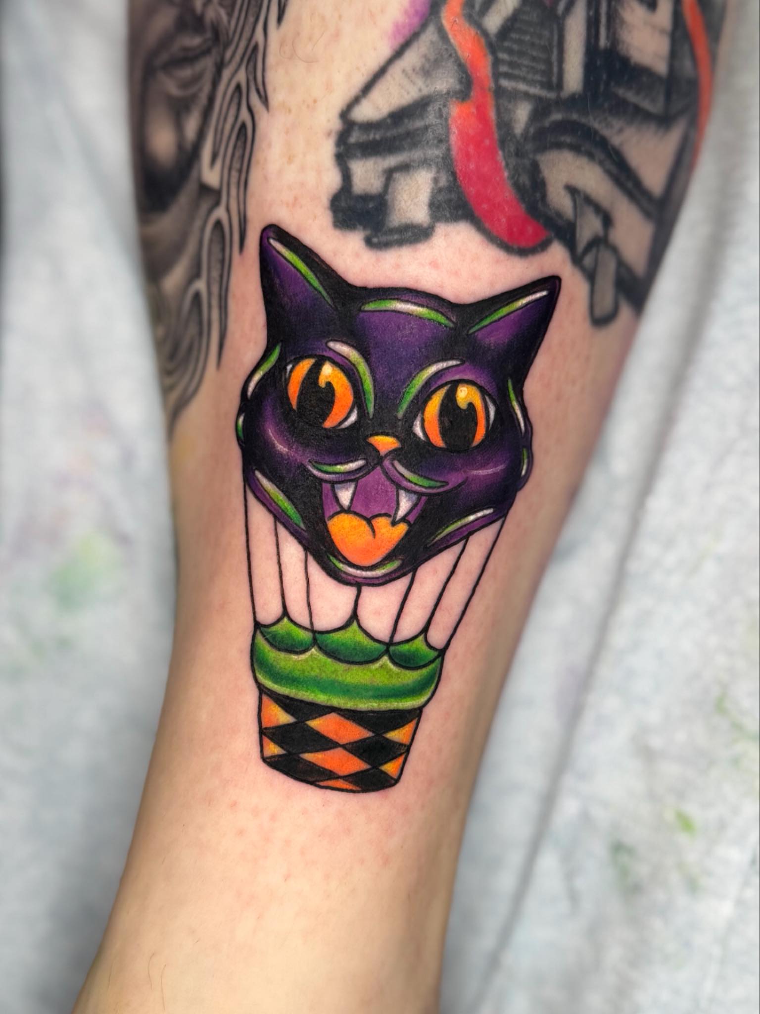 Black cat American traditional tattoo on the forearm by Breanna B