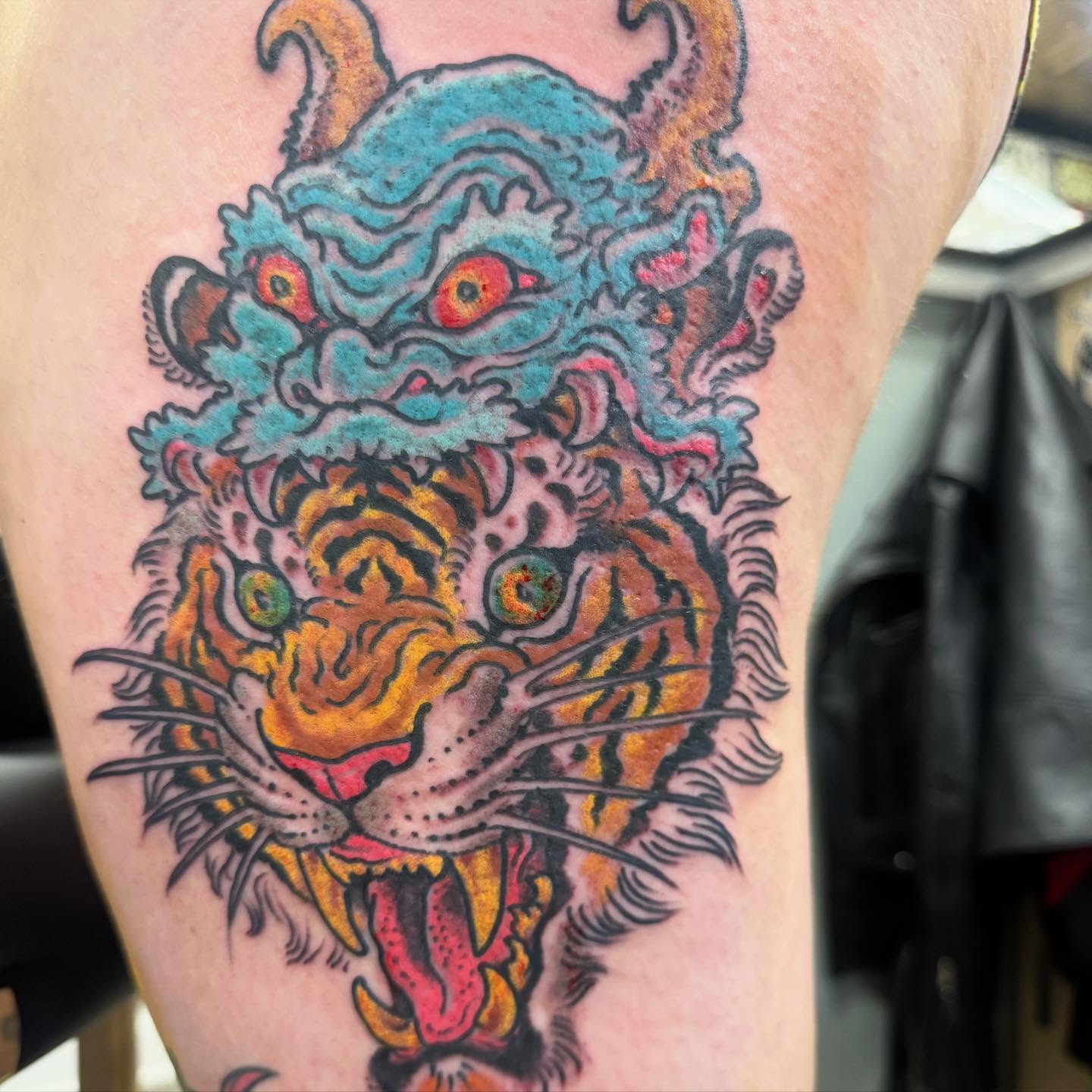 Tiger American traditional tattoo on the thigh by Tim Lehi, Oakland, California