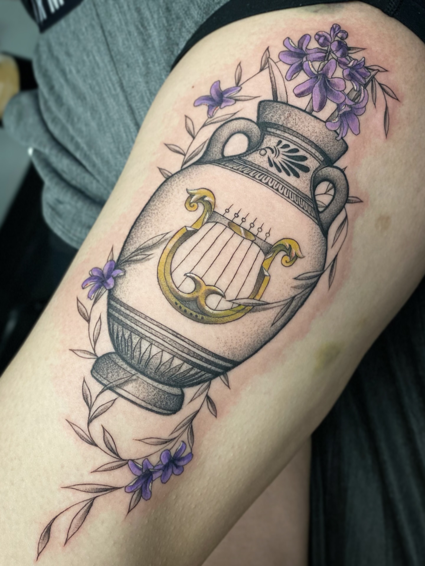 Lyre and amphora black and grey tattoo on the thigh by Seth Mullin, Hemet, California