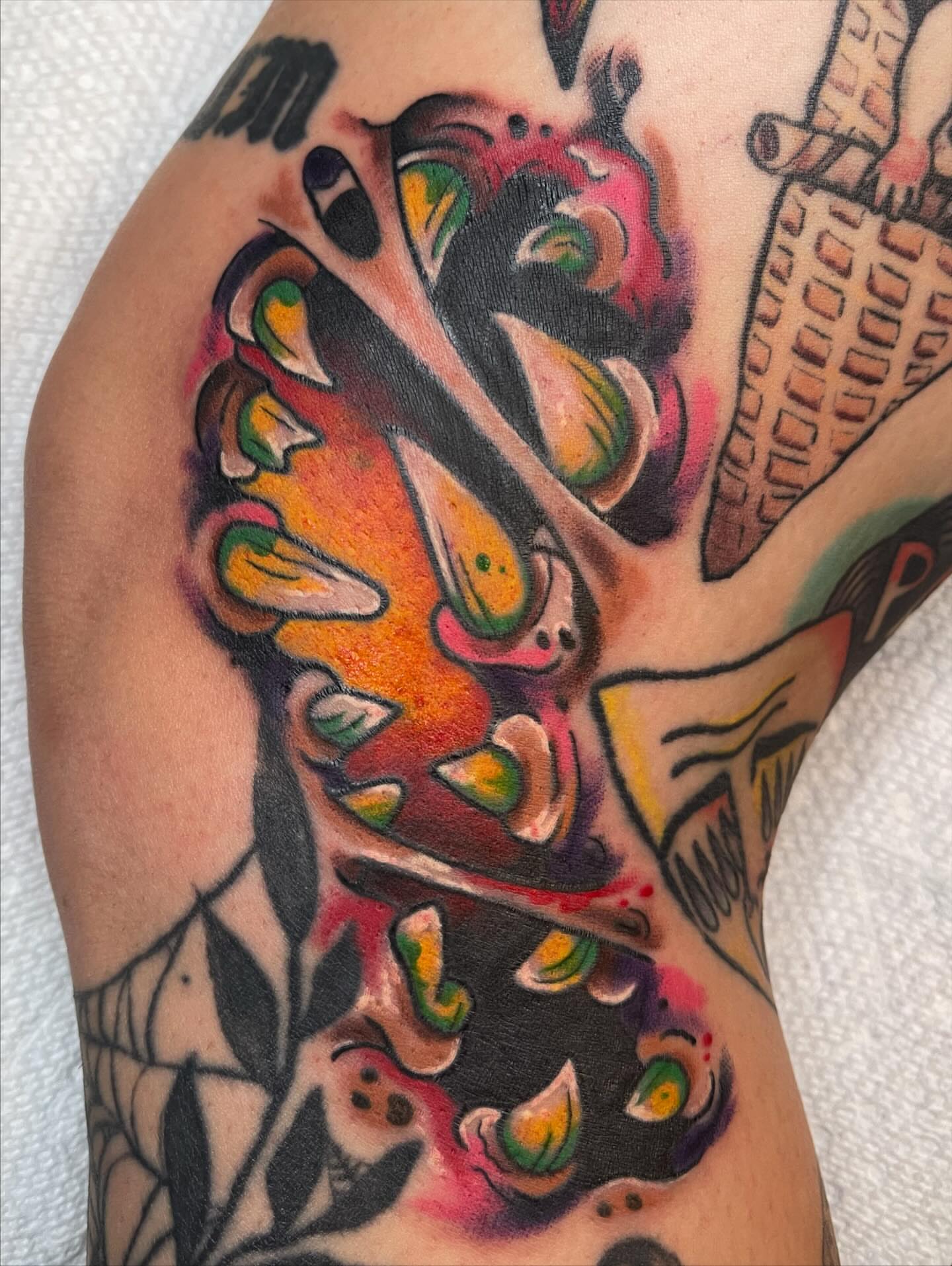 Abstract face American traditional tattoo on the upper arm by Josh Brownell