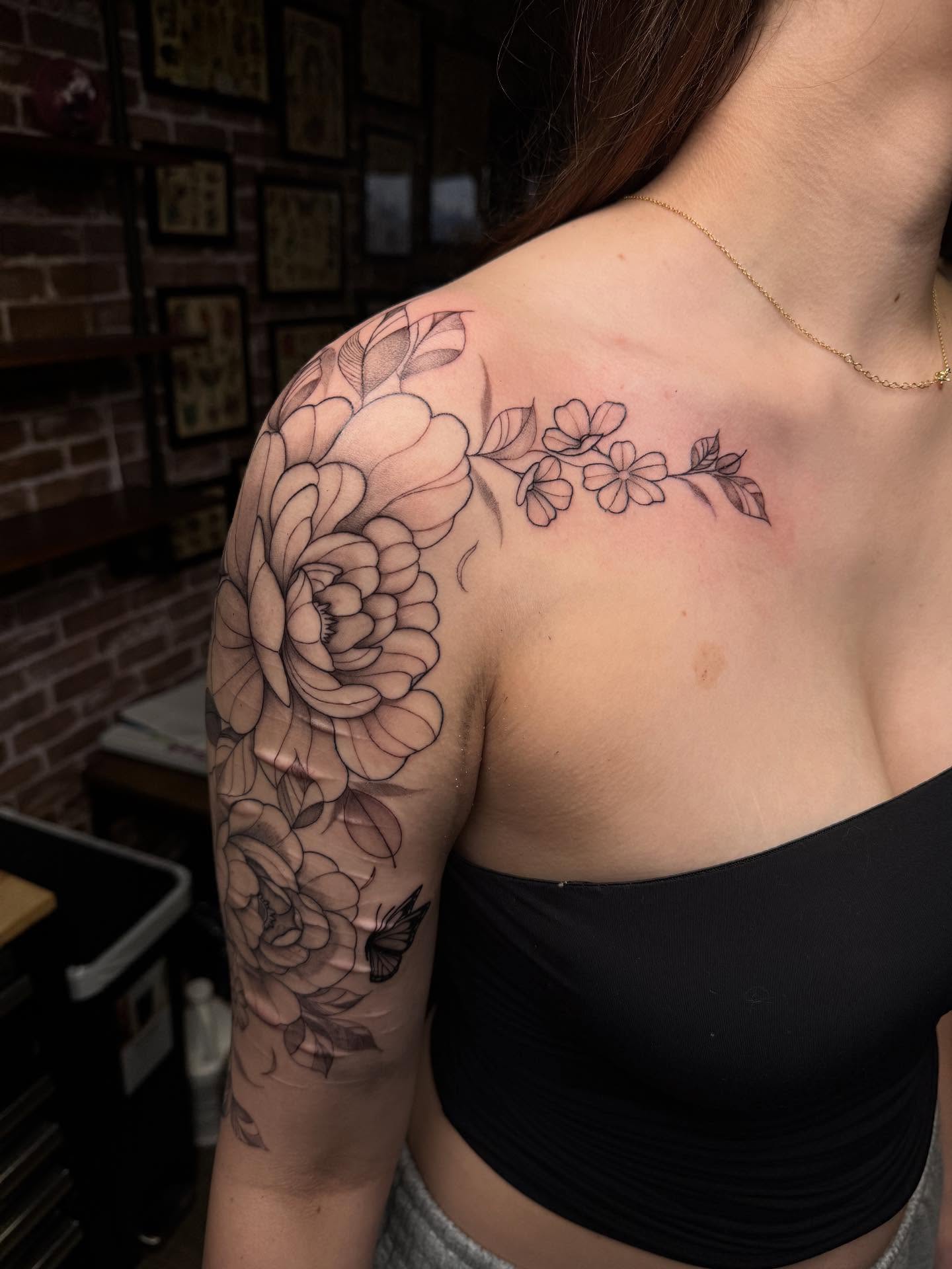 Floral bouquet realism tattoo on the shoulder by Mickey